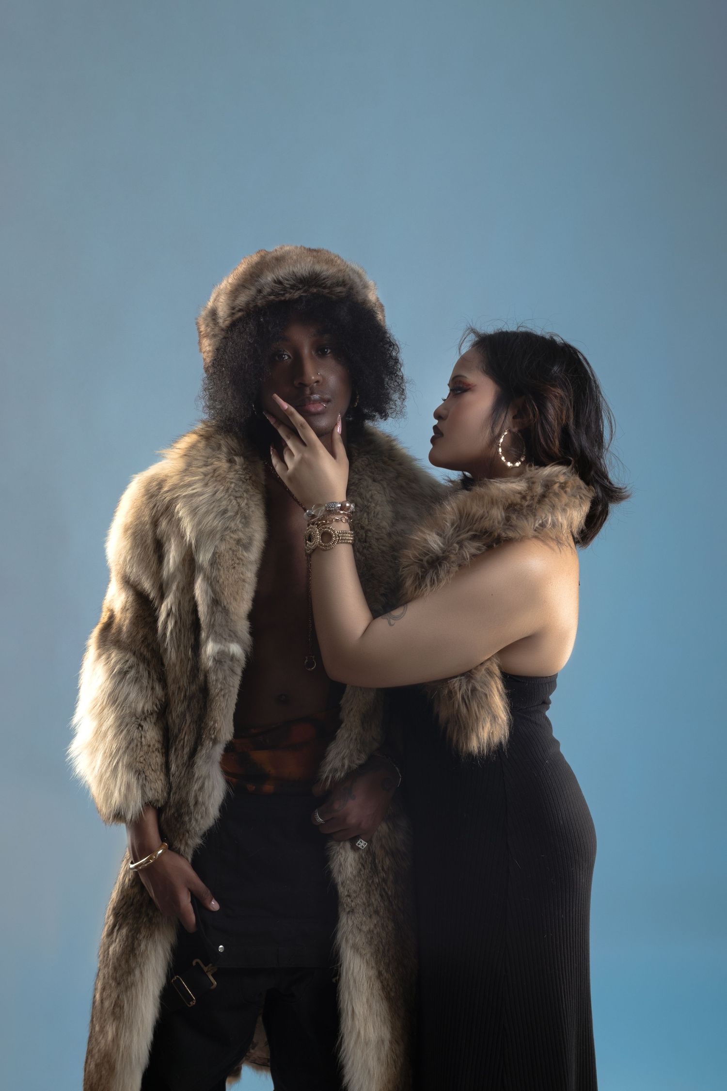 Fashion photoshoot sequence featuring a fur coat and dramatic poses against a blue backdrop.