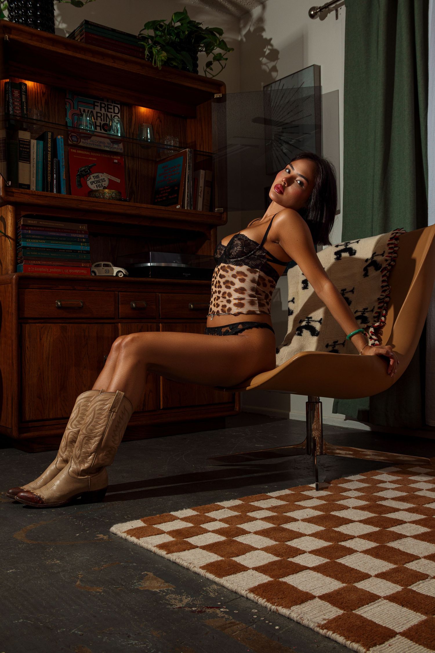 Artistic poses on a checkered floor in a dimly lit room with wooden furniture.