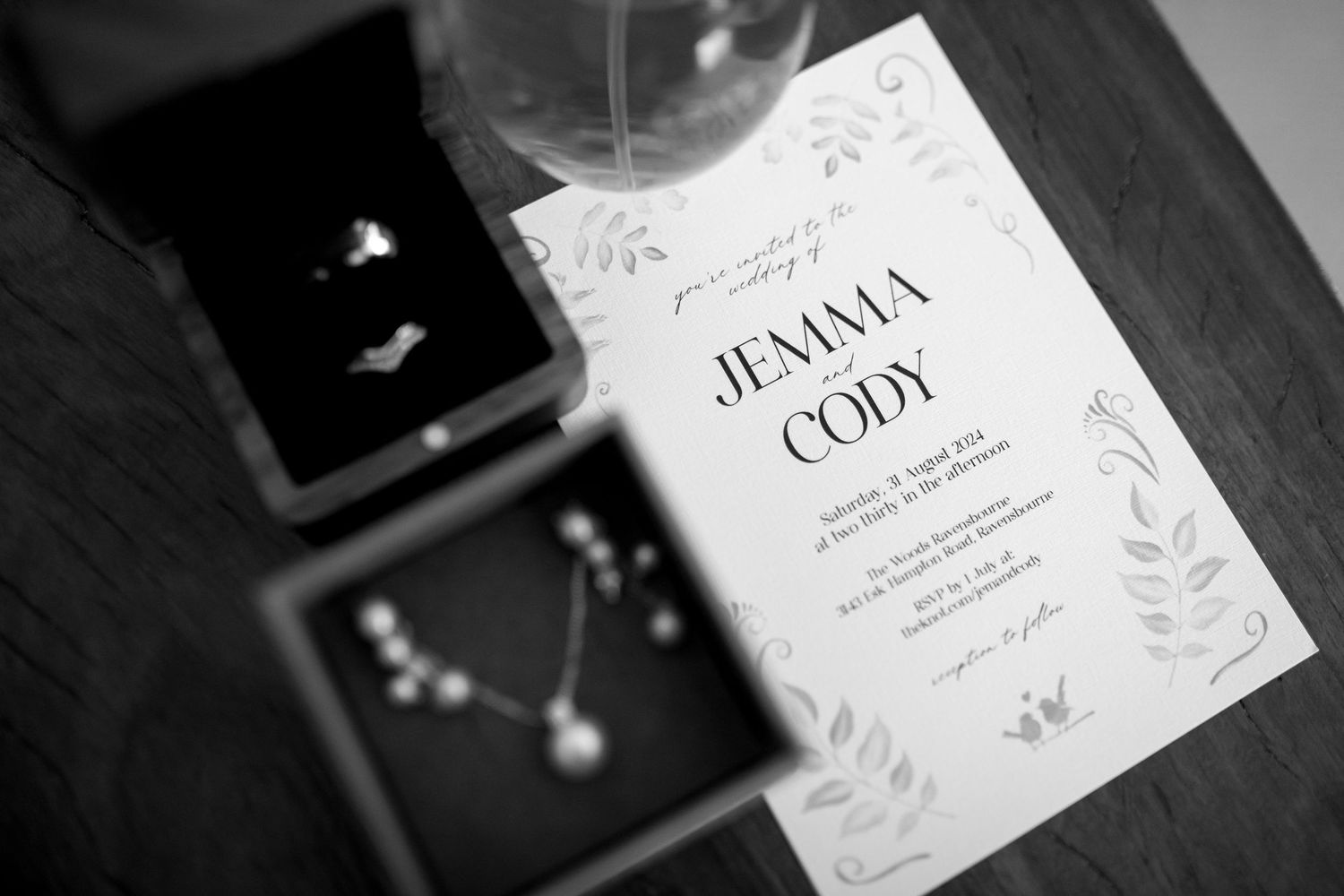 Elegant wedding invitation with floral design details.