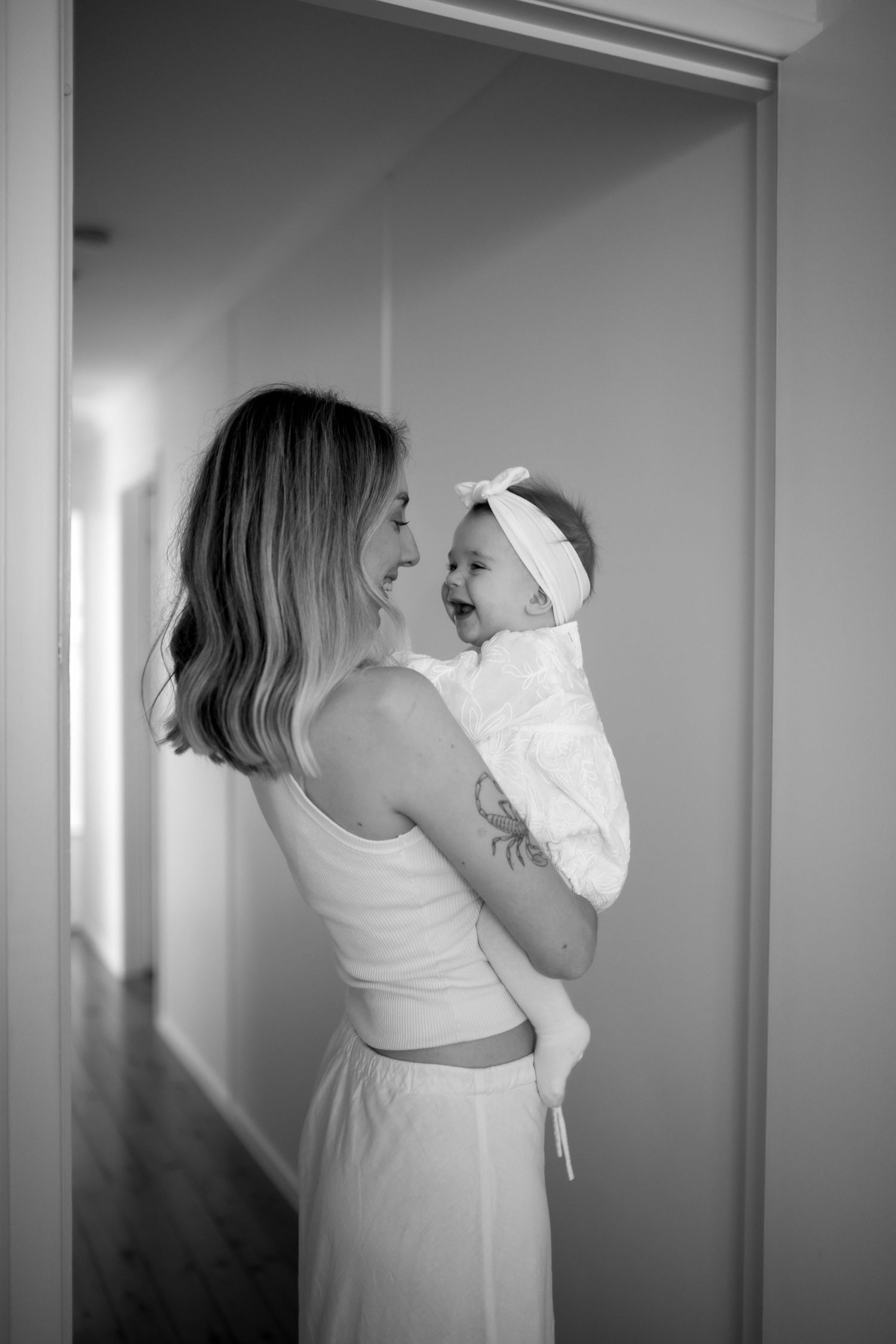 Black and white images showing tender moments in a bright white room.
