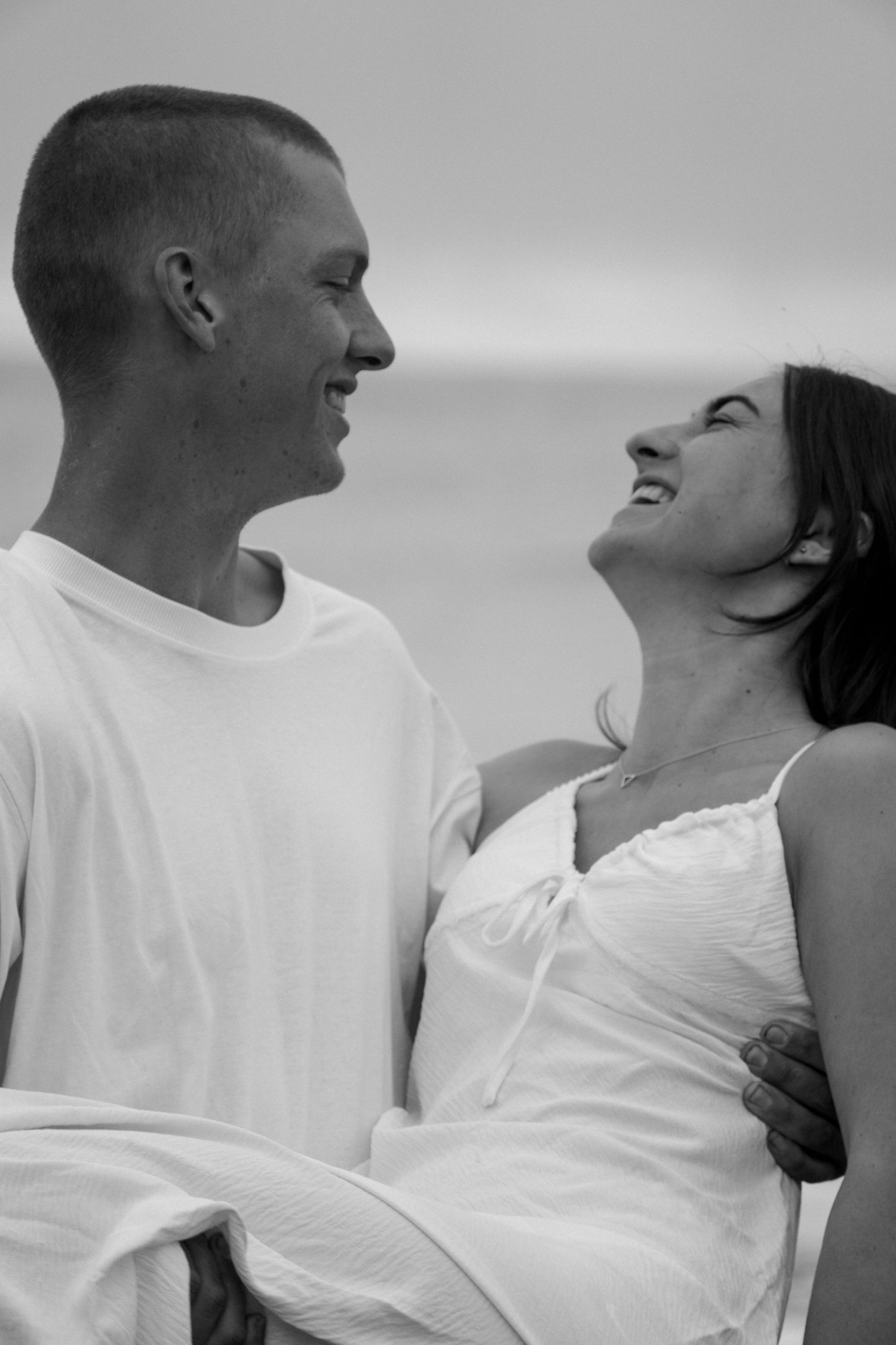male holding female on beach