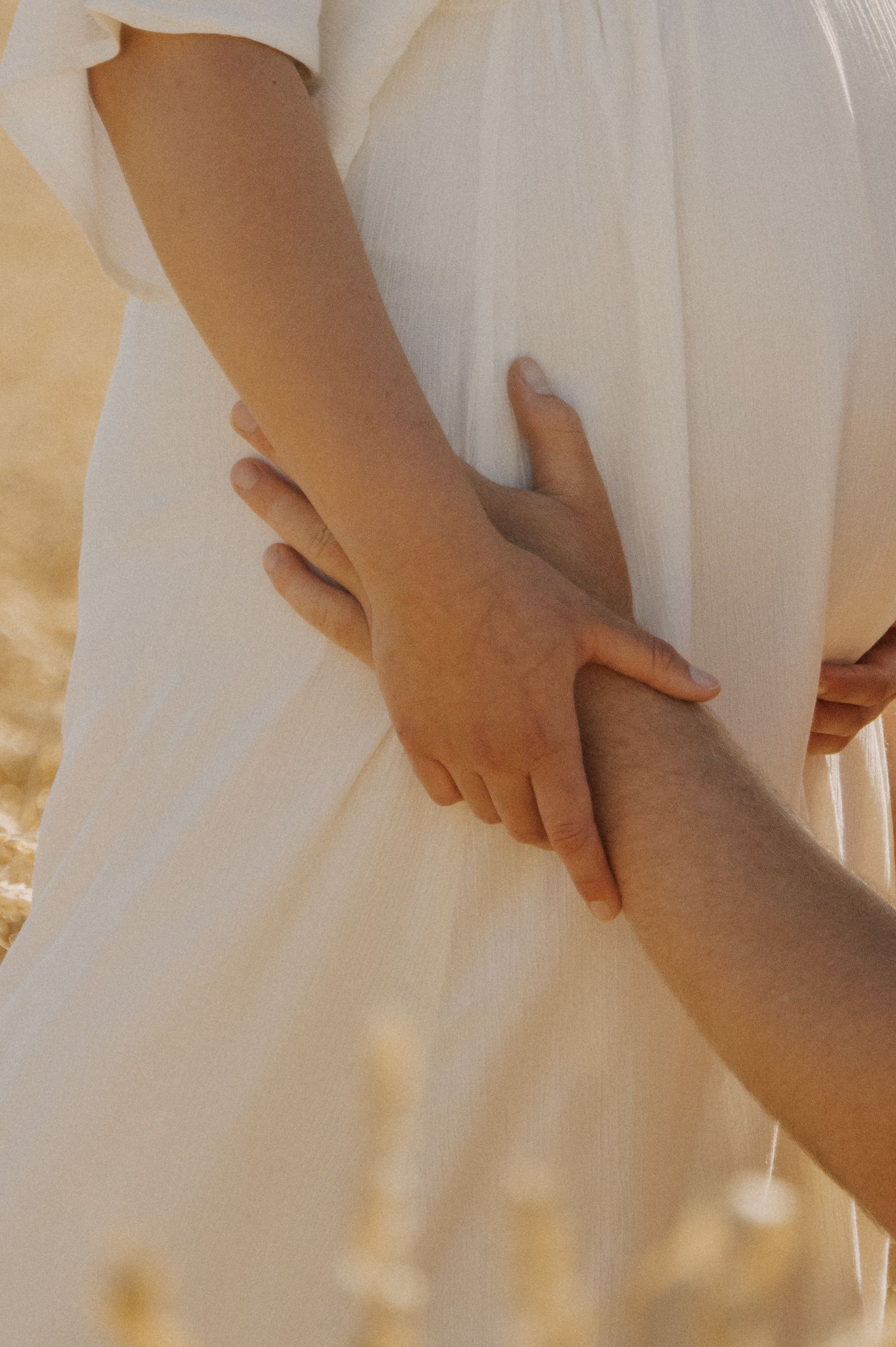 couple reaching for eachother