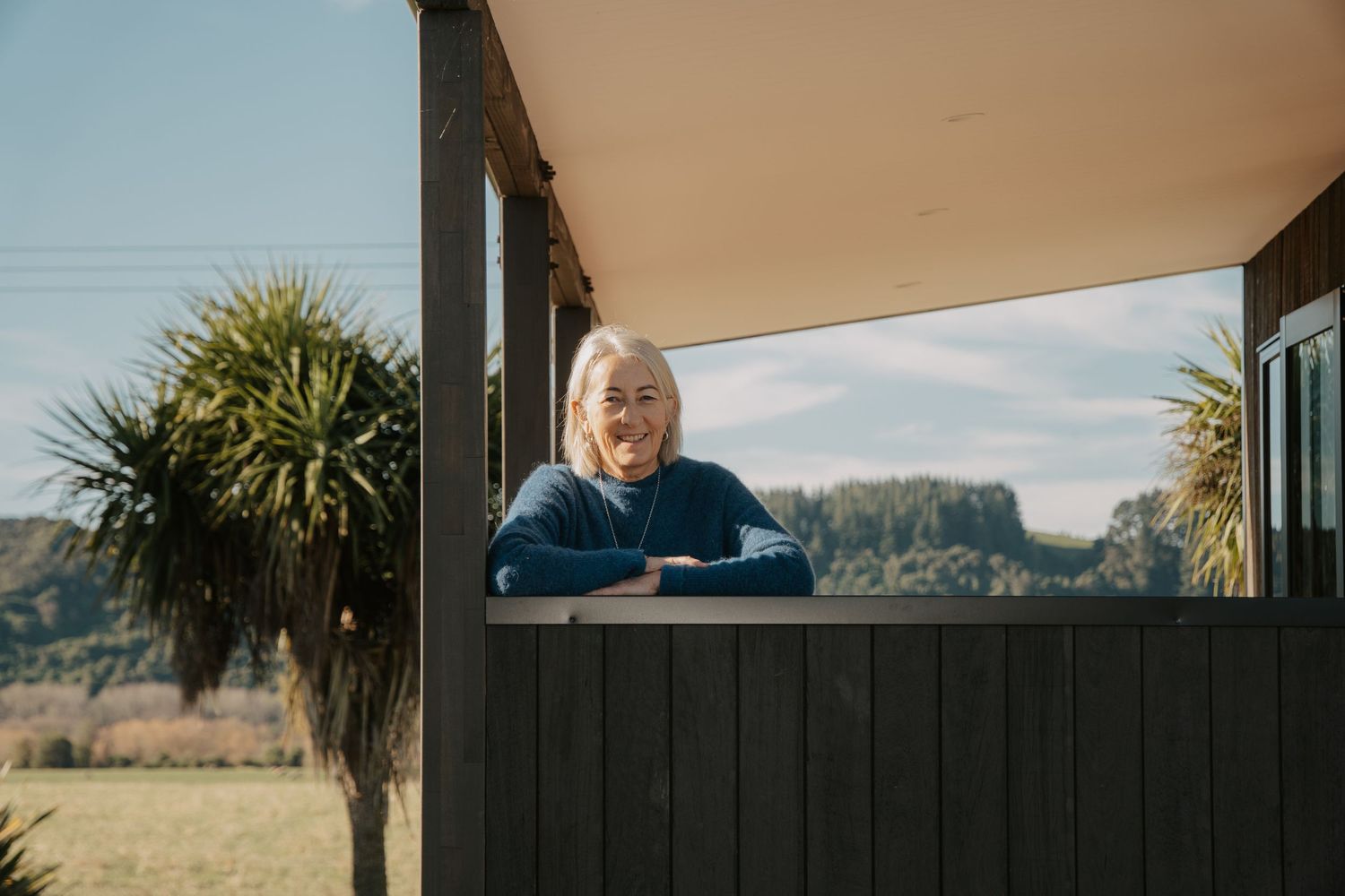 Air bnb owner leaning on house