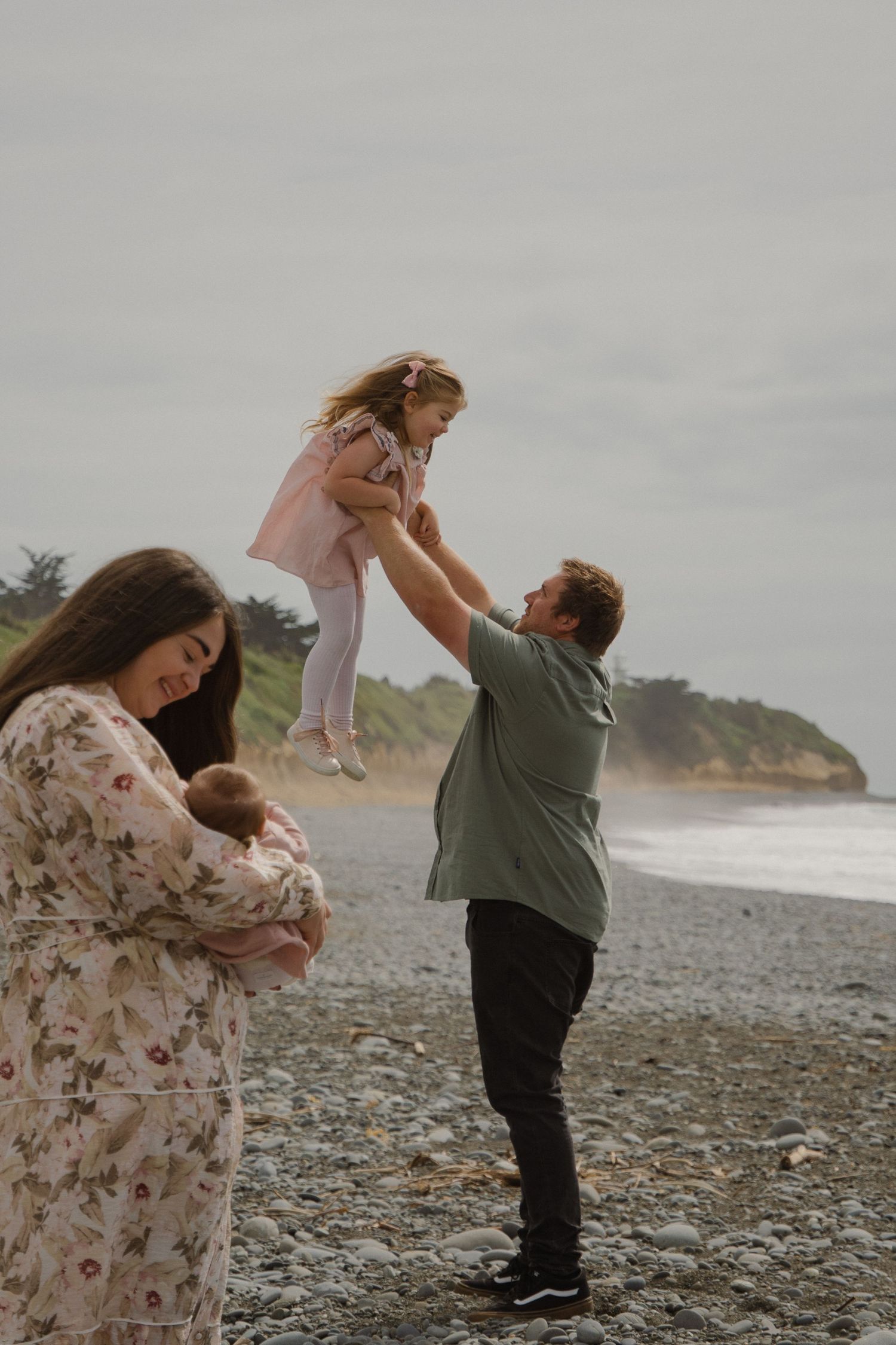 family photo, parent and kids cuddling on beach