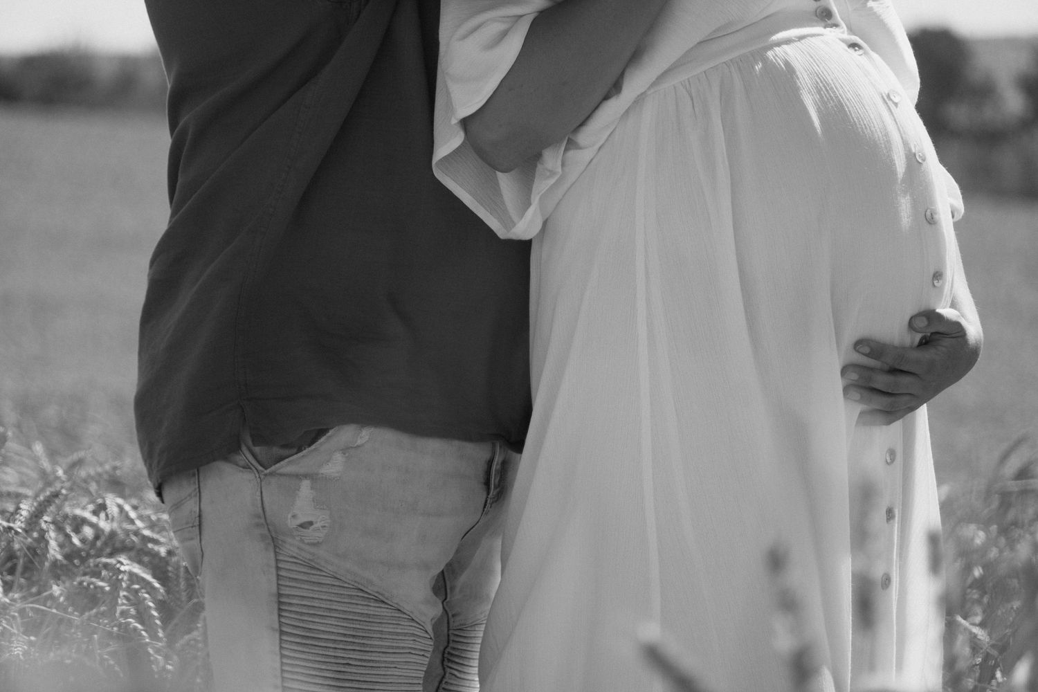 couple holding maternity bump