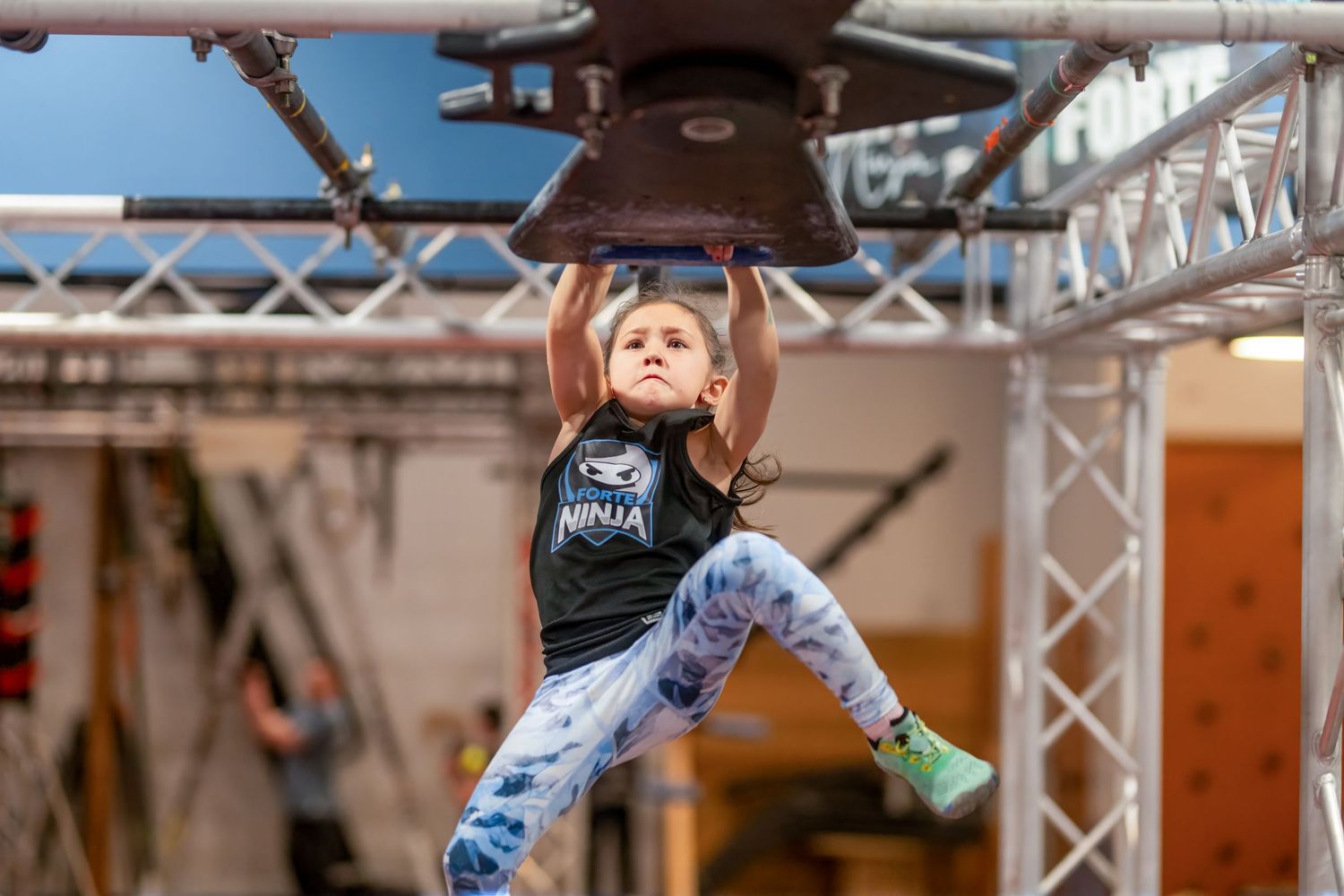 Athlete performing acrobatic moves on gymnastics equipment during competition.
