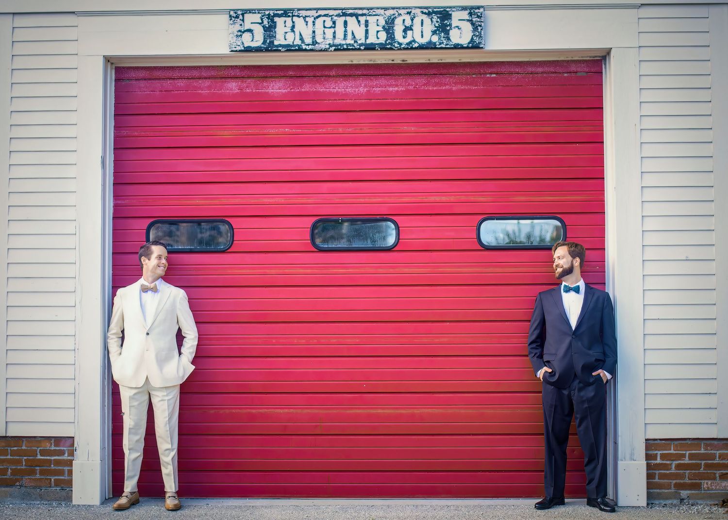 Fire station exterior with bright red garage doors and Engine Co. 5 signage.