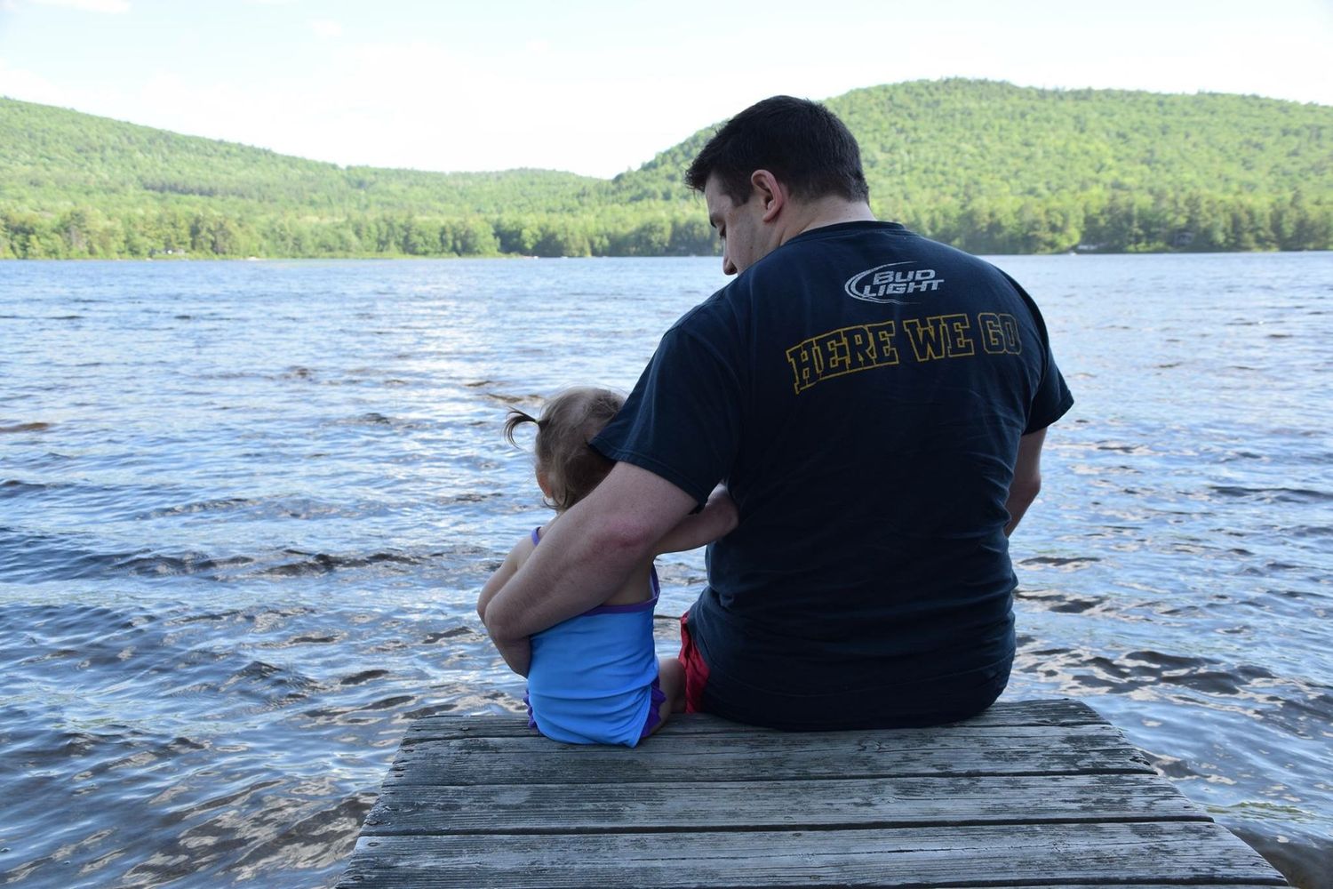 A series of photos showing people sitting at the edge of a lake or pond with trees visible in the background.
