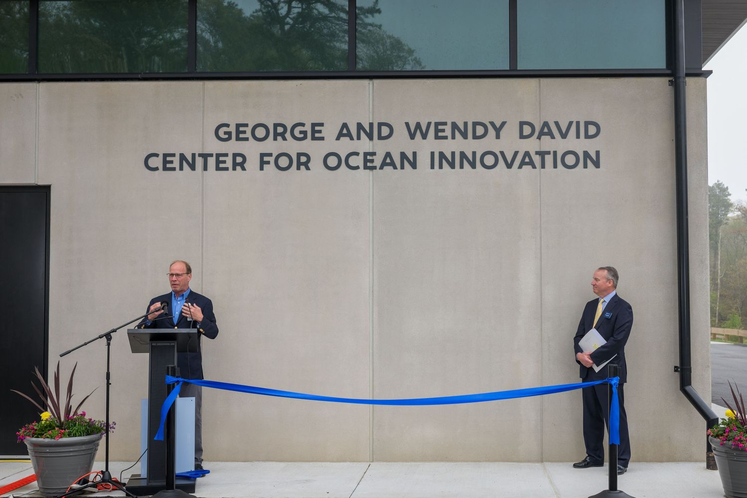 Exterior signage and entrance of the Center for Ocean Innovation building with blue ribbon.