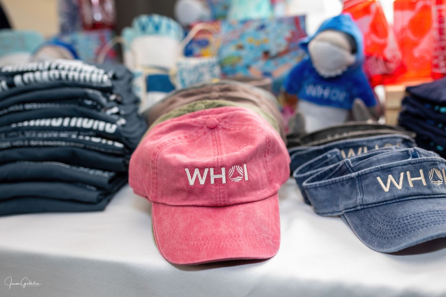 Collection of branded baseball caps in various colors displayed on a table.