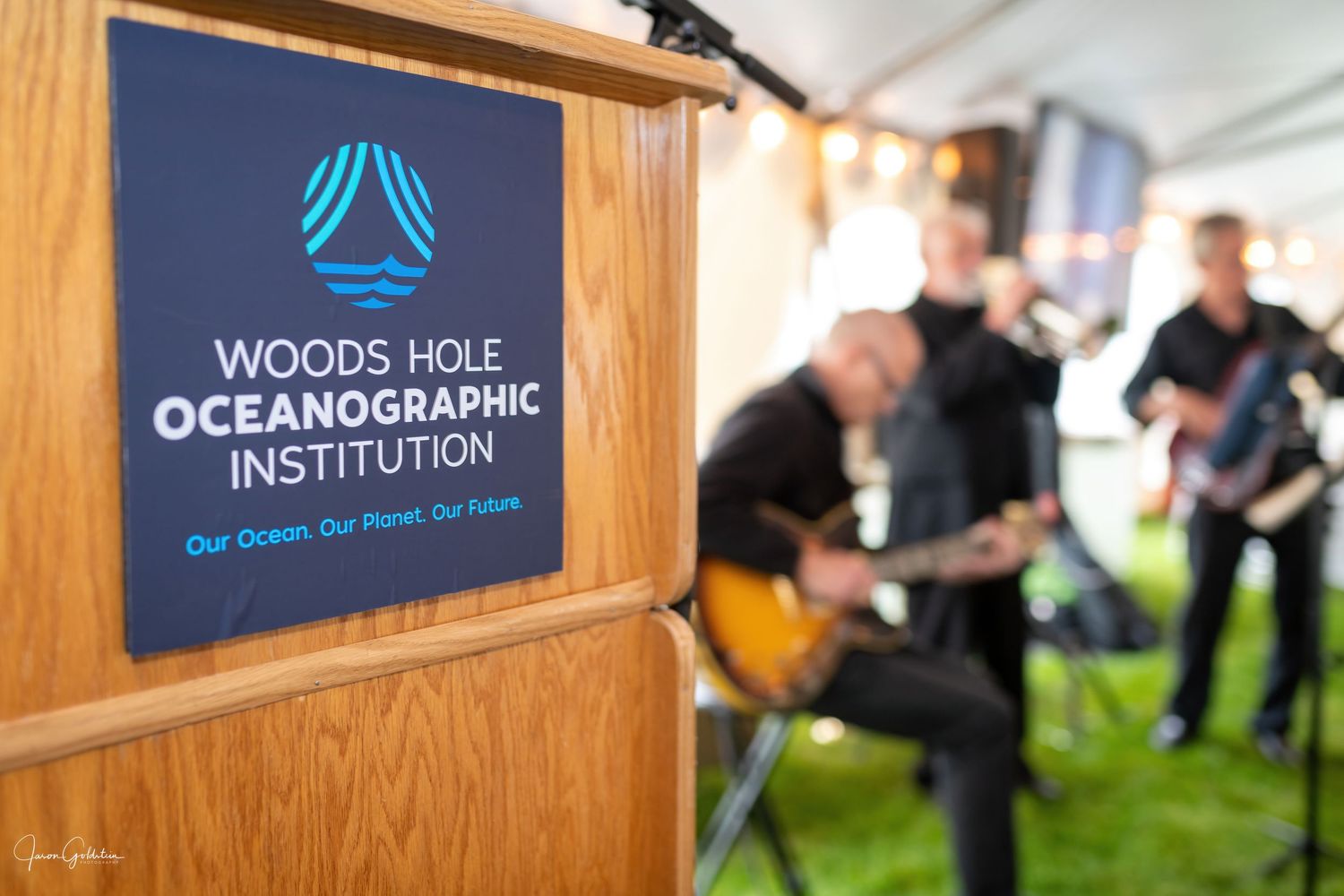Wooden wall displays featuring the Woods Hole Oceanographic Institution logo and branding.