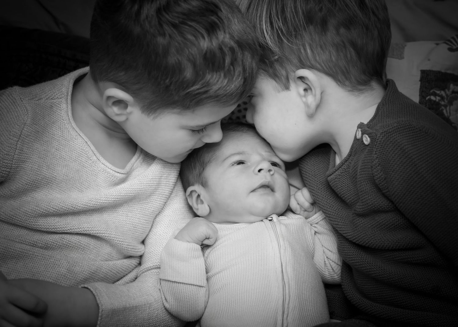 Black and white portrait of siblings in intimate moment.