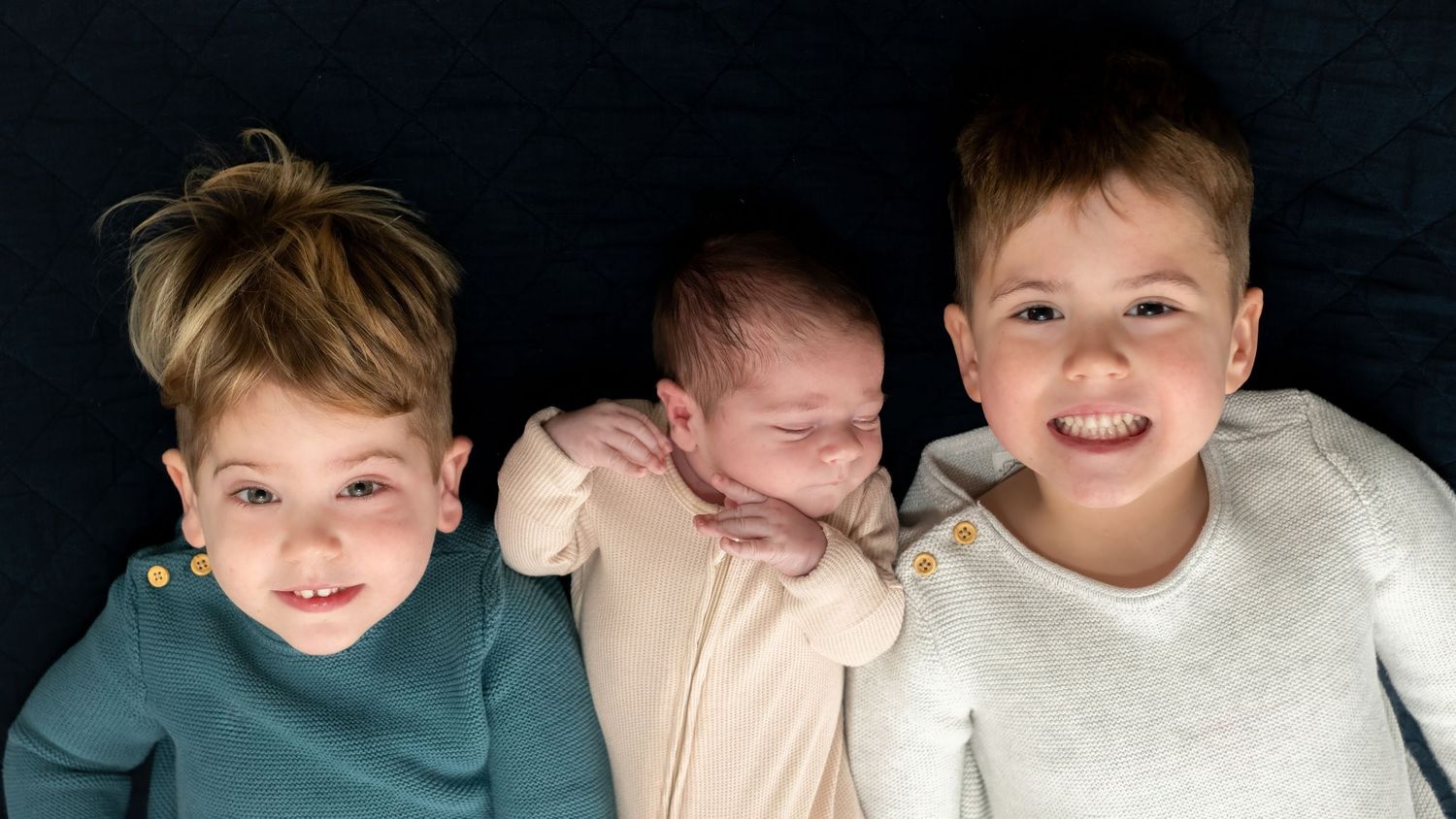 Children sharing joyful expressions in casual portrait.