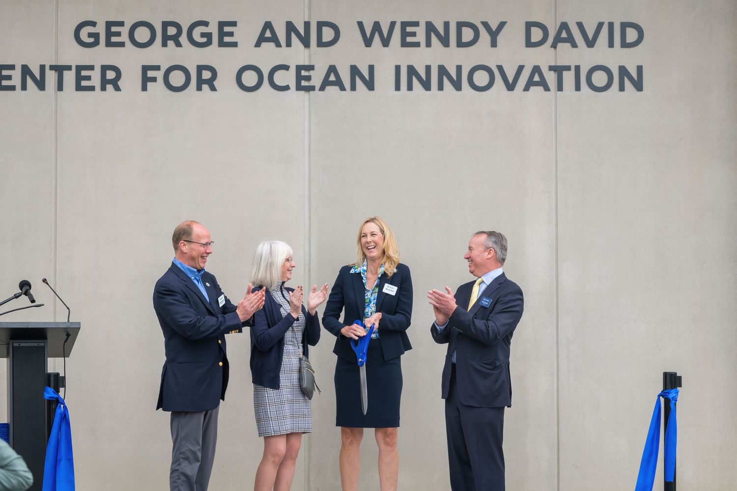 Attendees share a lighthearted moment during the center's opening celebration.