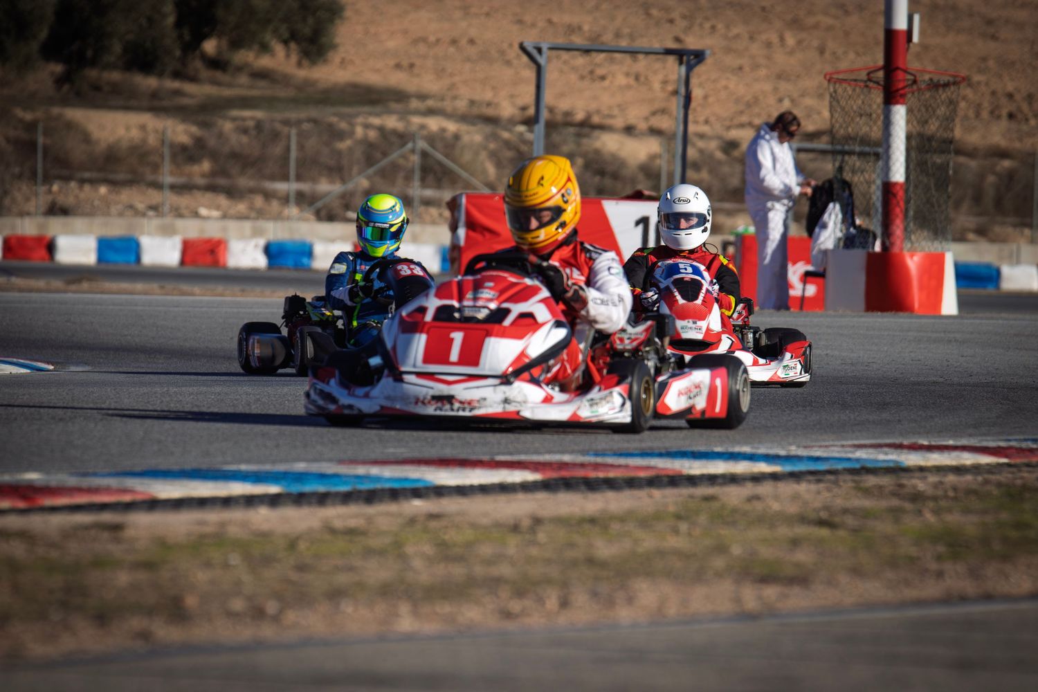 Multiple go-karts battle for position during an intense race sequence.