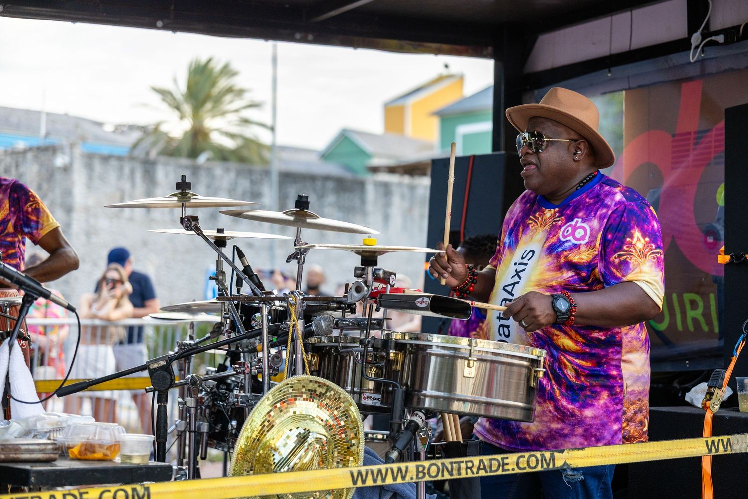 Musical performance setup with drums and equipment on outdoor stage.