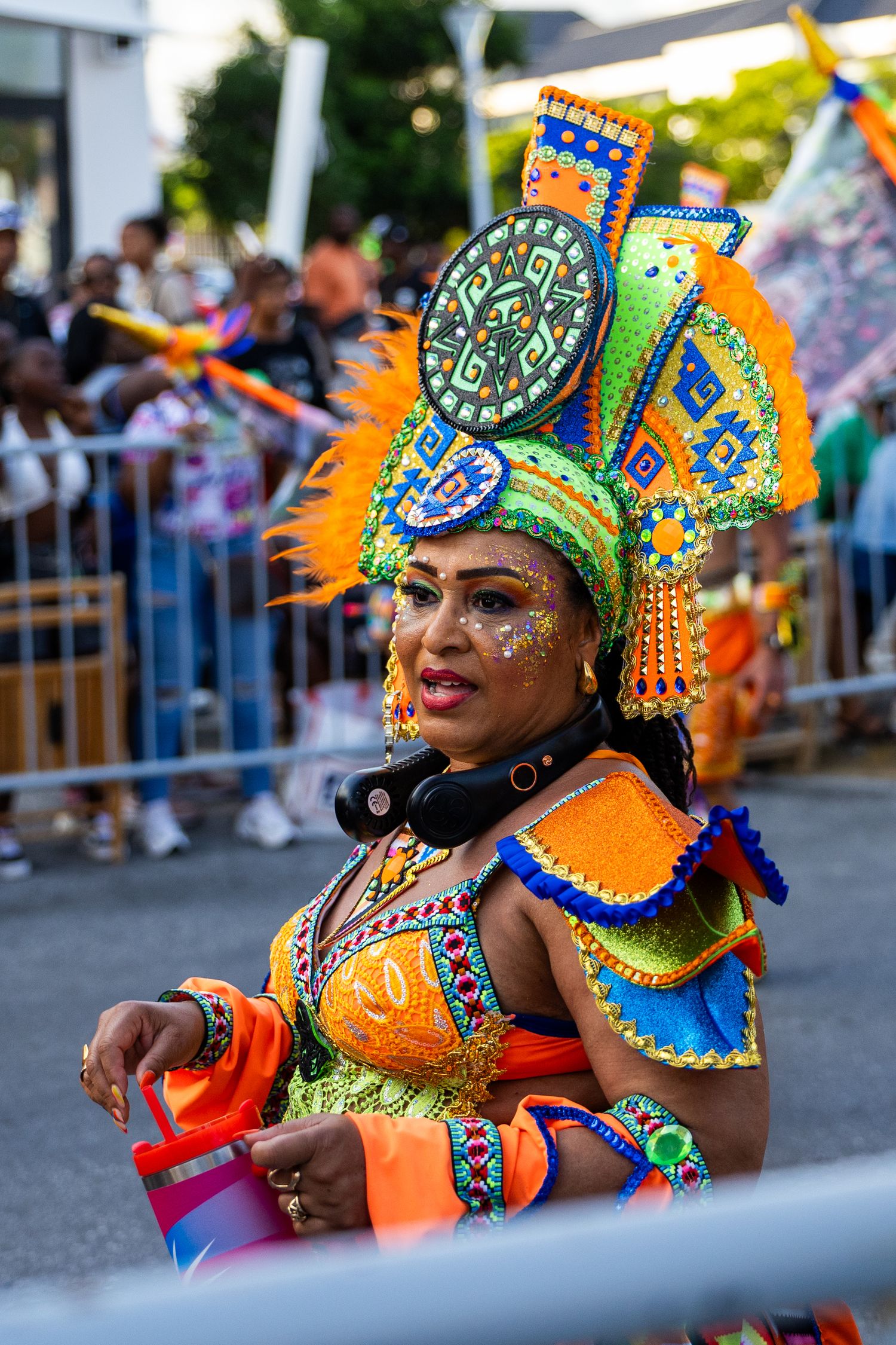 Carnival dancers wearing elaborate headdresses and bright costumes perform during a street festival.