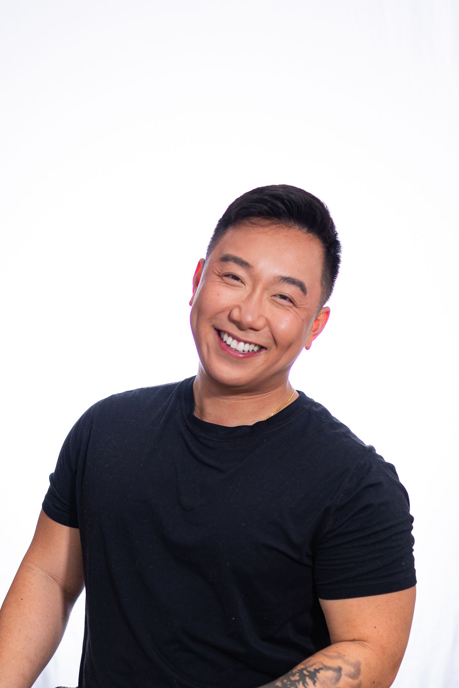 Person wearing a black t-shirt showing different expressions in a series of headshots against white background.