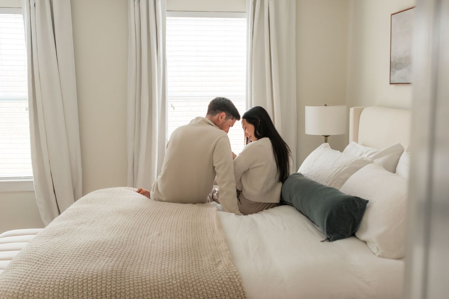 Intimate lifestyle photos on a white bed with soft natural window light.