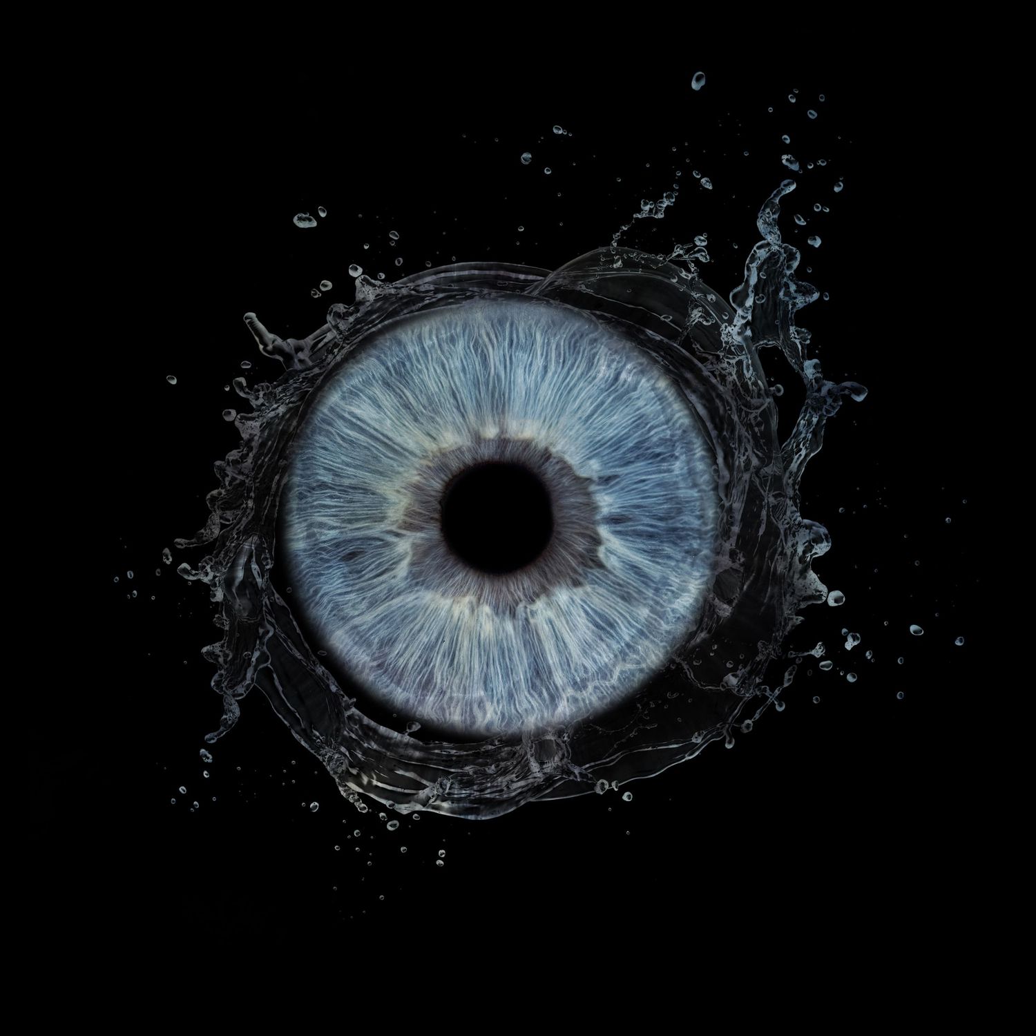 A blue human iris surrounded by a water splash on a dark black background.