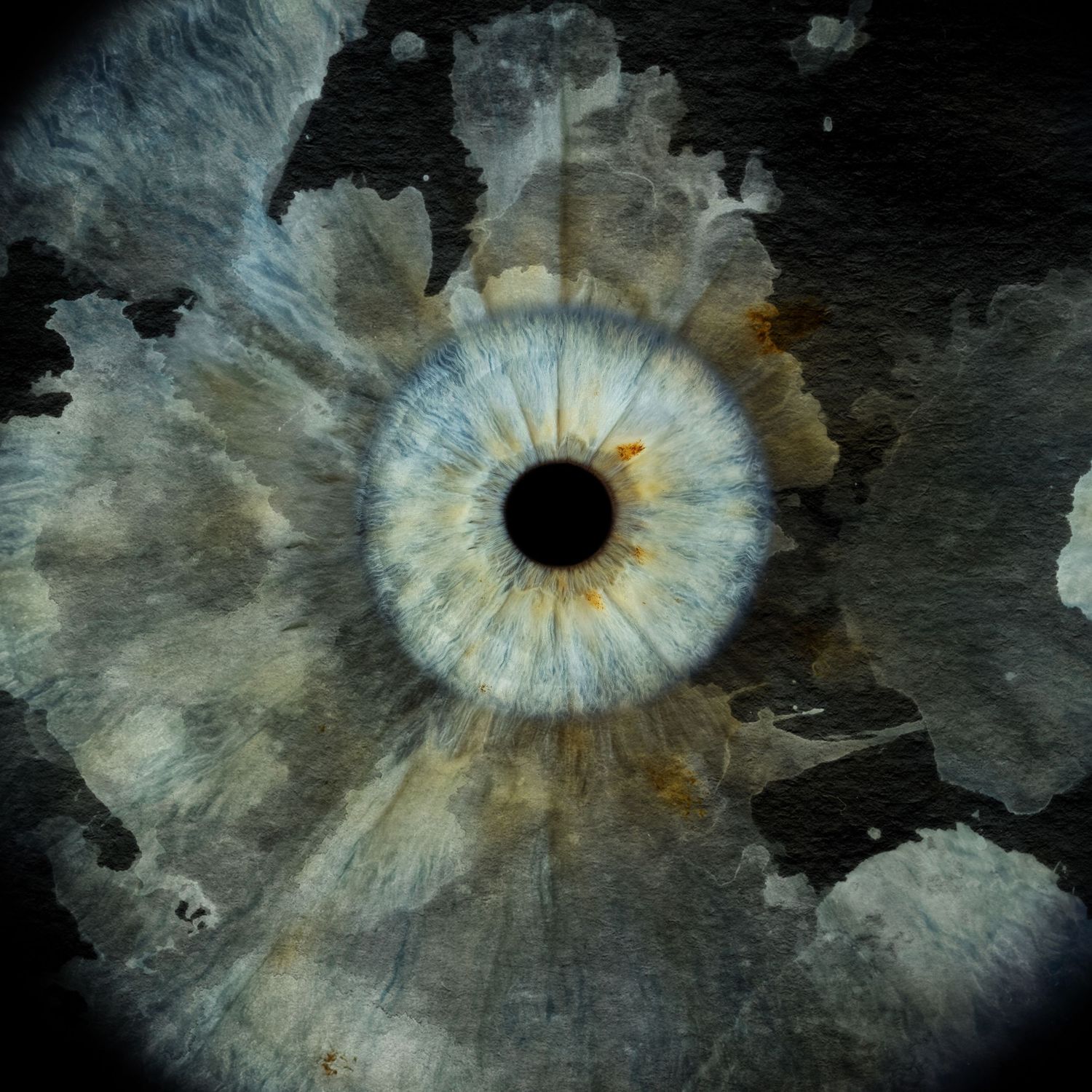 A close-up blue human eye iris surrounded by abstract watercolor splatter texture on a dark moody background.