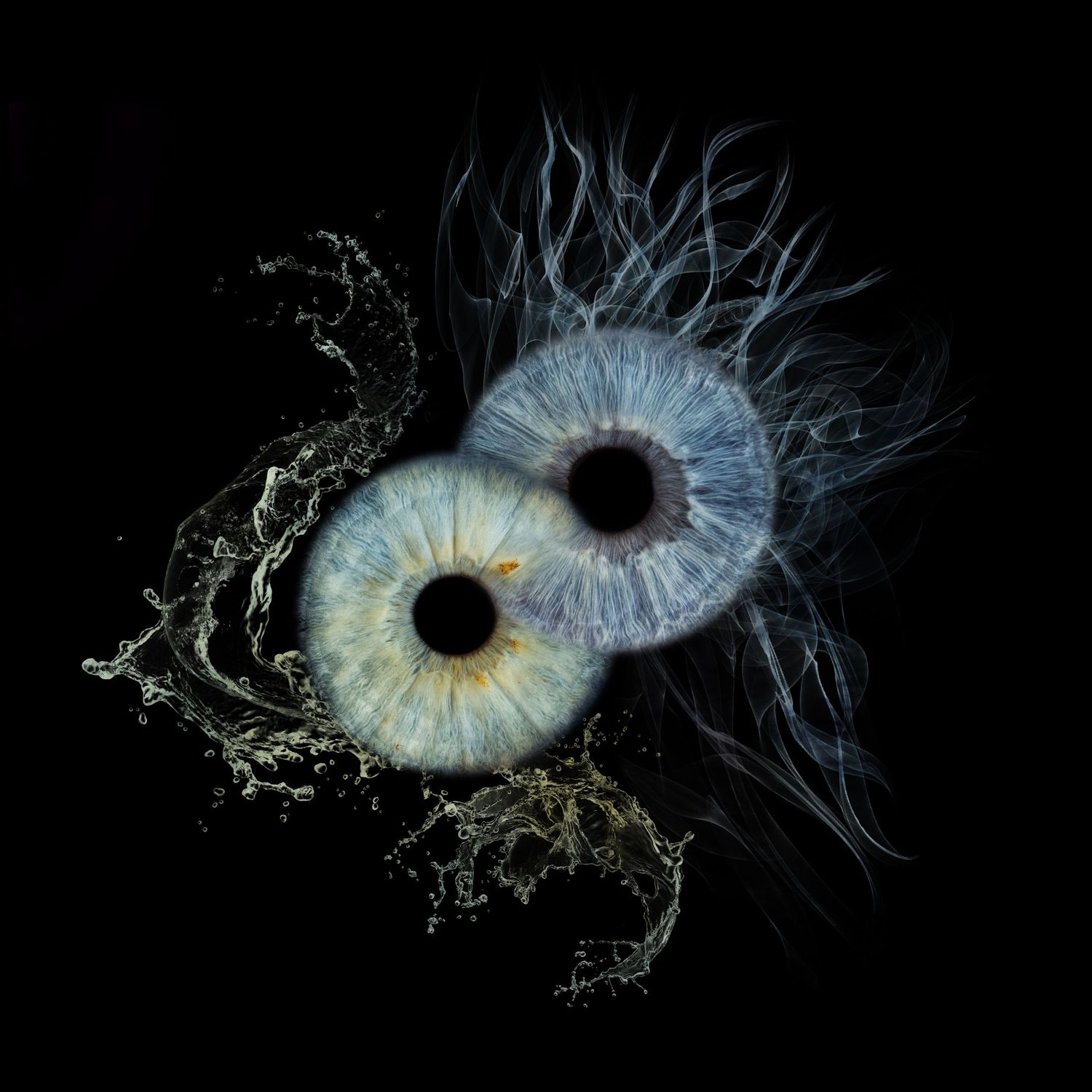 Two blue and gold human irises arranged in a yin-yang formation with water splashes on black background.