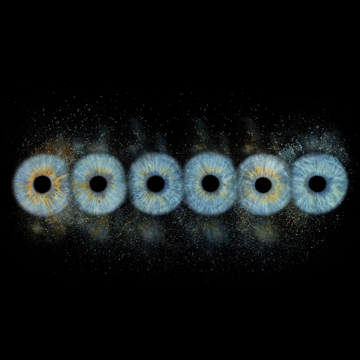 Six blue human irises arranged in a row against a black background with golden glitter particles.