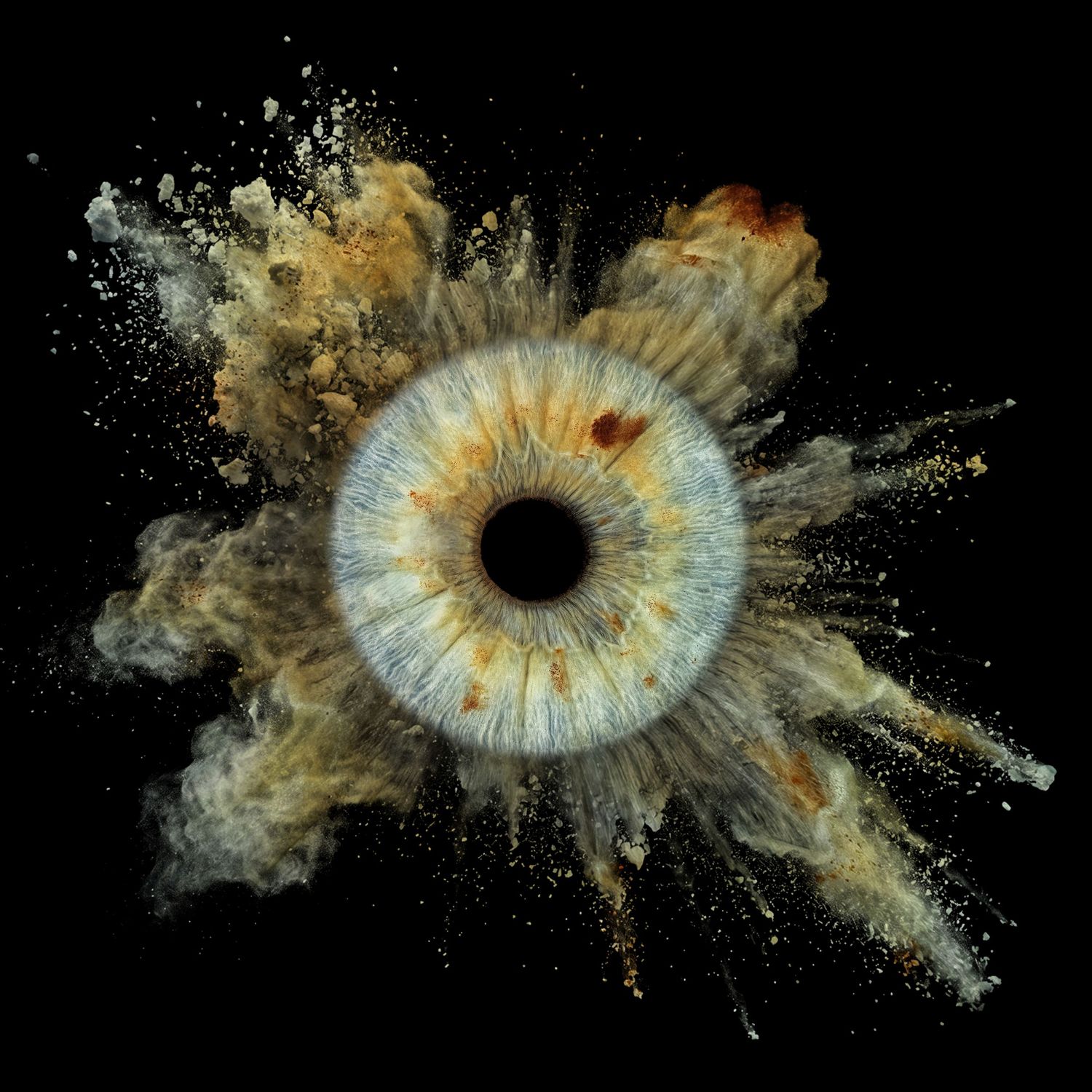 Dramatic macro photo of a blue human iris surrounded by an explosive burst of golden dust particles.