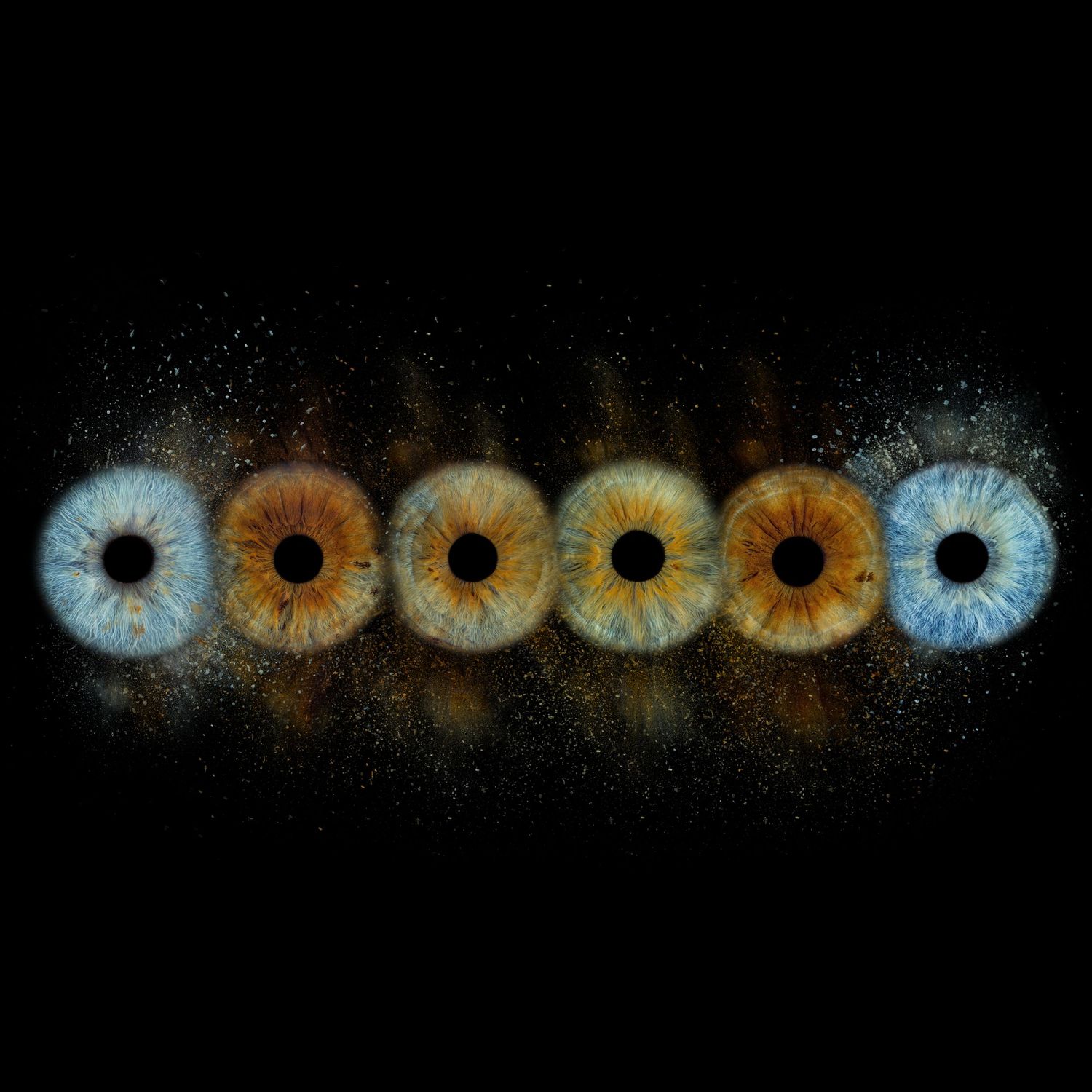 Six human eyes in a row showing color variation from blue to brown, displayed against a black background with light particles.