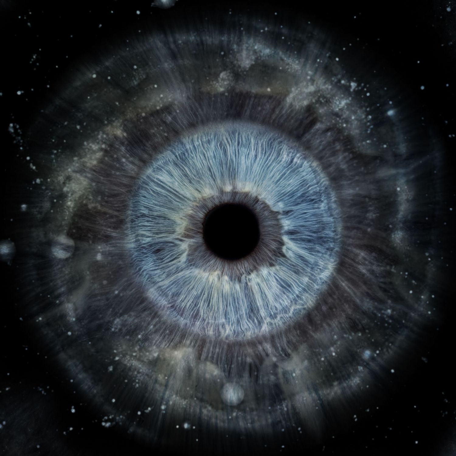 Blue human iris with cosmic galaxy texture radiating outward on a dark space background.