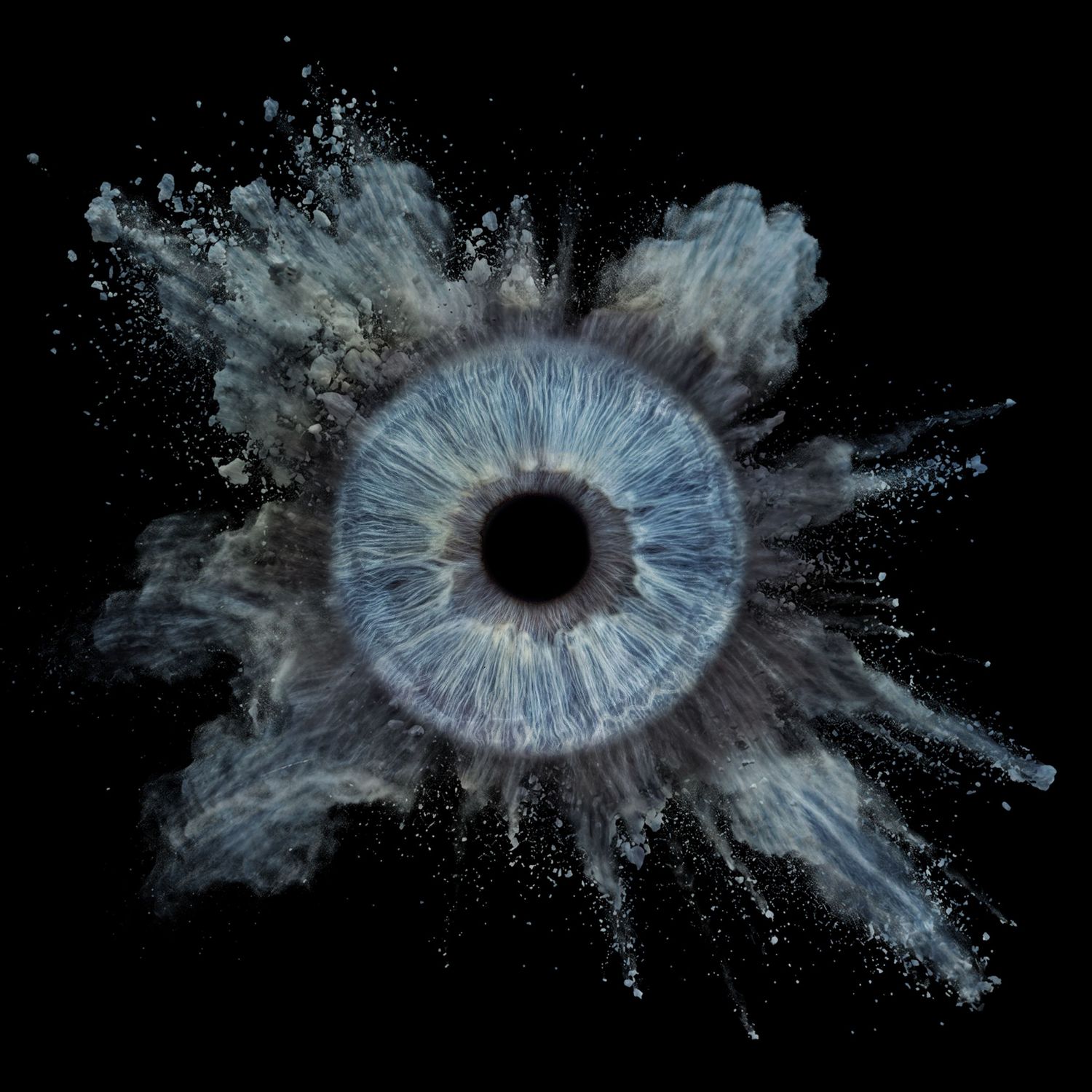 A blue human iris surrounded by a dramatic powder explosion on a black background.