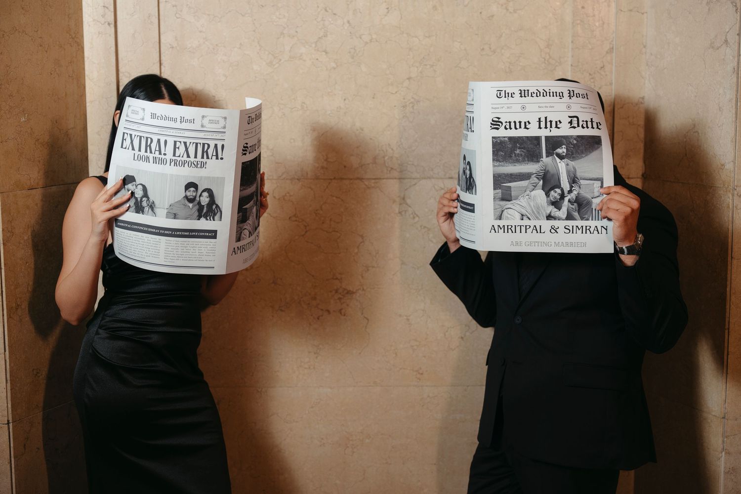 Couple in black attire hide their faces behind Wedding Post newspapers announcing a save the date in a playful engagement photo.
