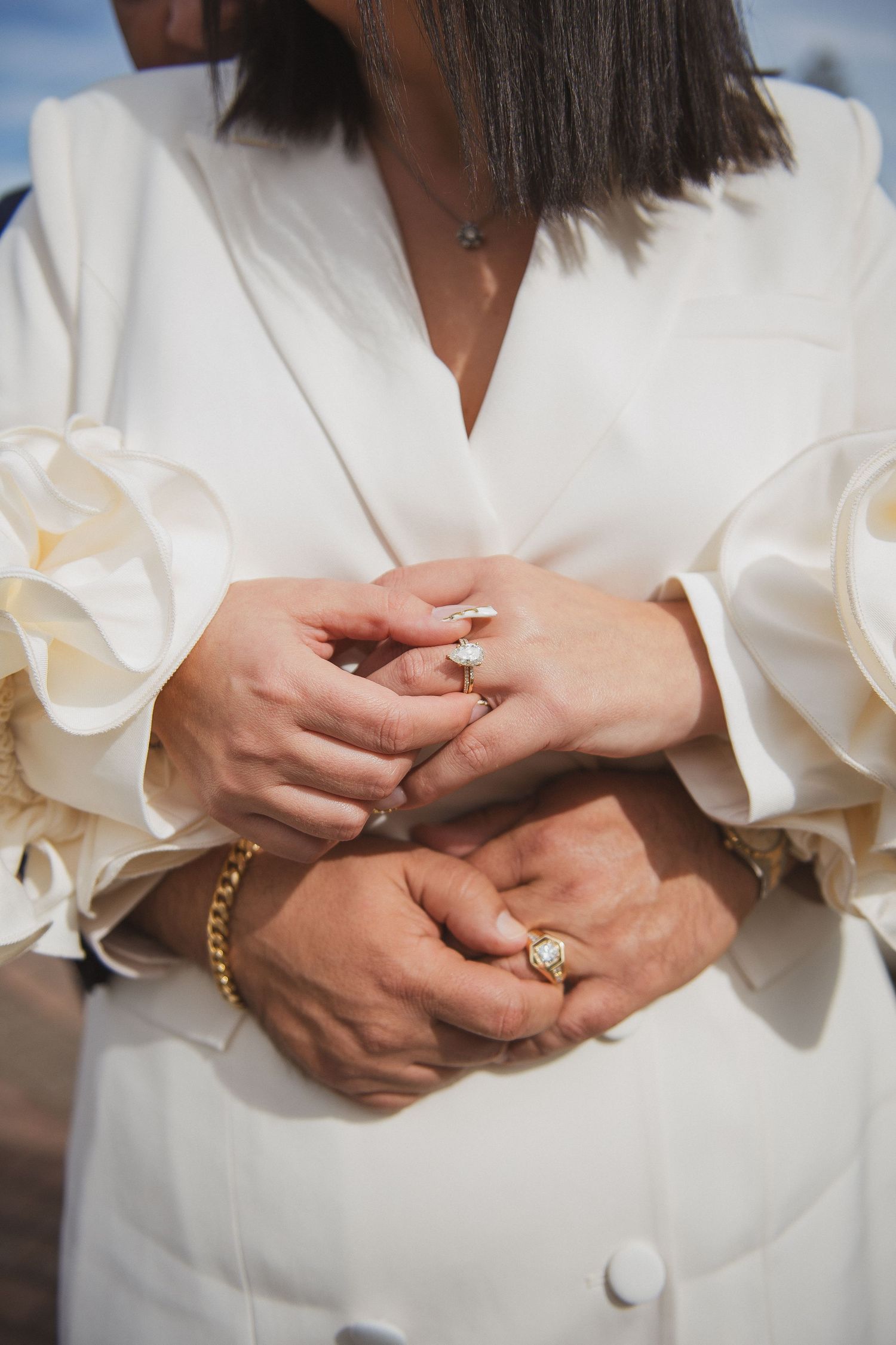 A couple embracing and putting their wedding rings on
