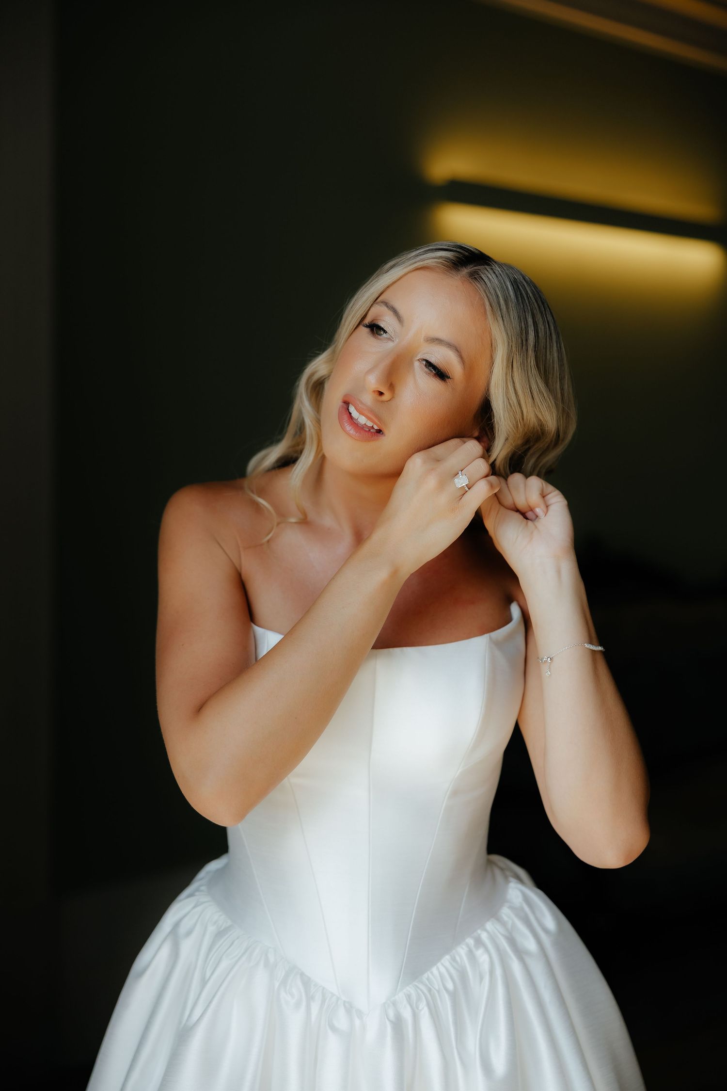 A person in a white formal dress dances joyfully in a sequence of candid celebration photos.