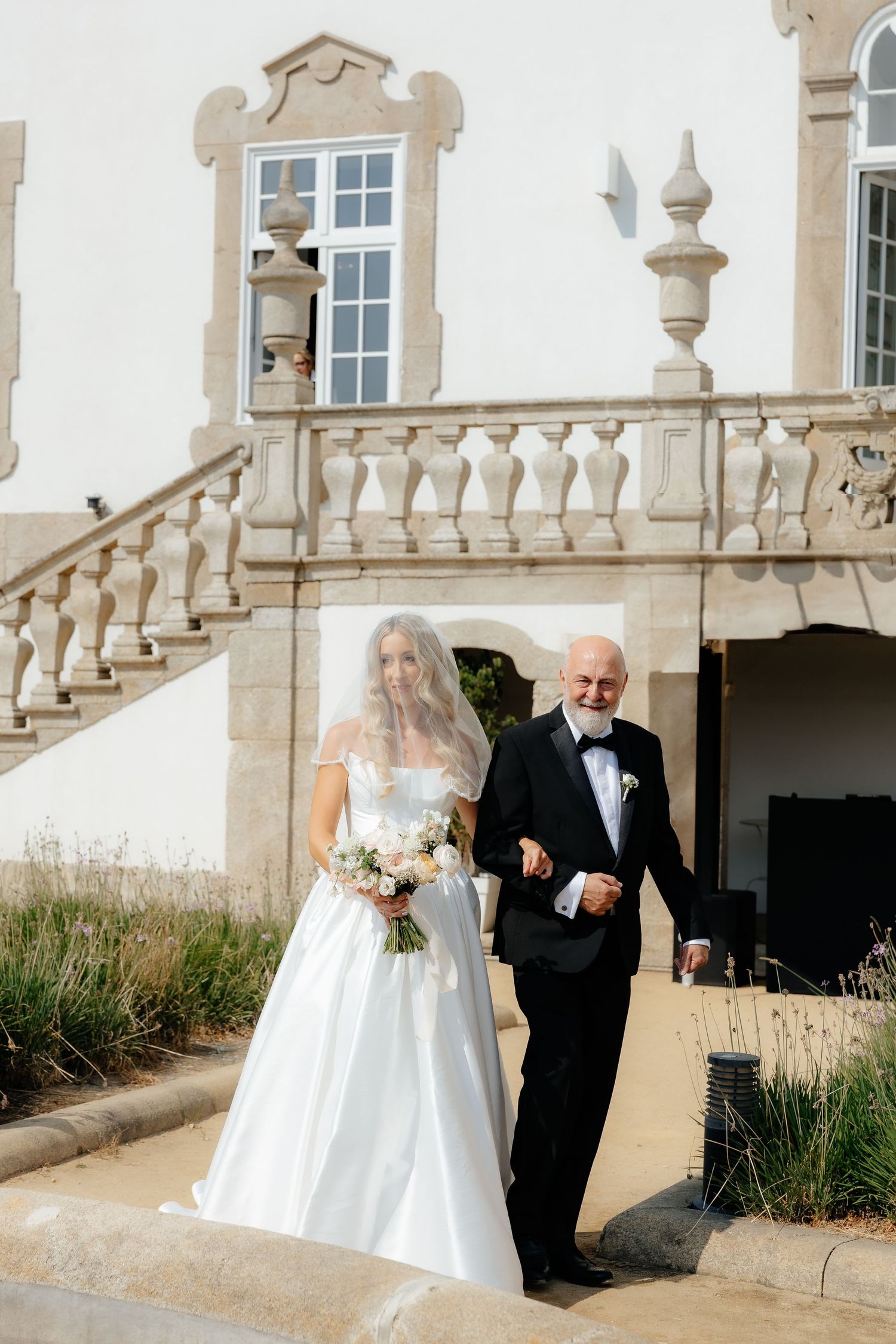 A sequence of wedding photos showing a bride and escort walking down an elegant stone balustrade pathway at a historic venue.
