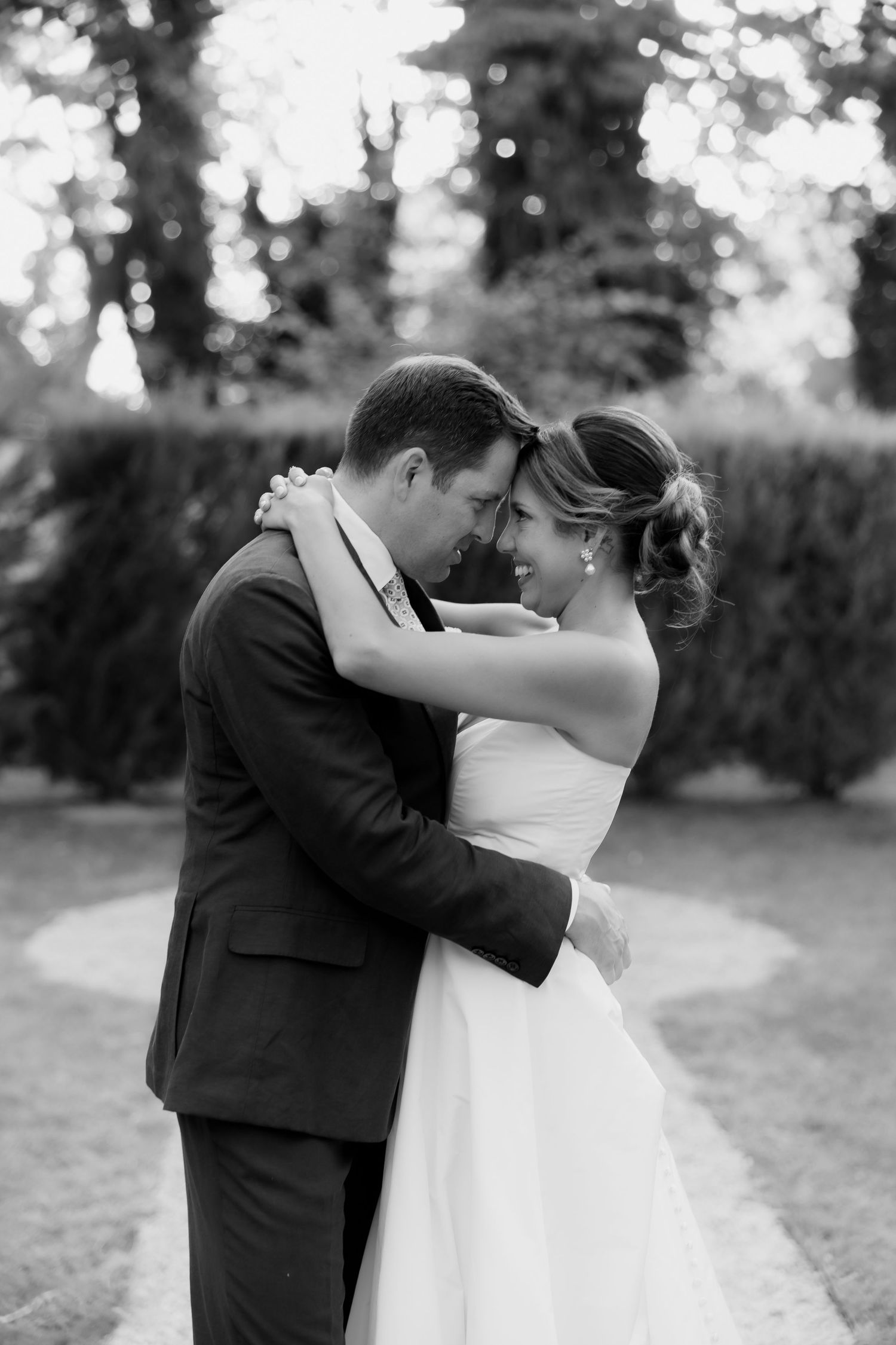 Black and white romantic wedding portraits captured in an outdoor garden setting.