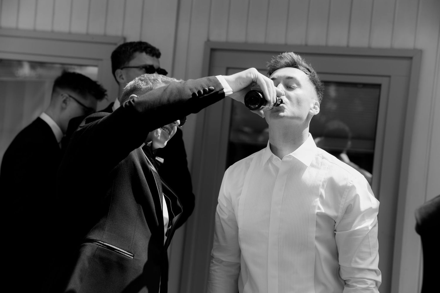A black and white collage of six similar photos showing someone drinking from a glass against a light background.