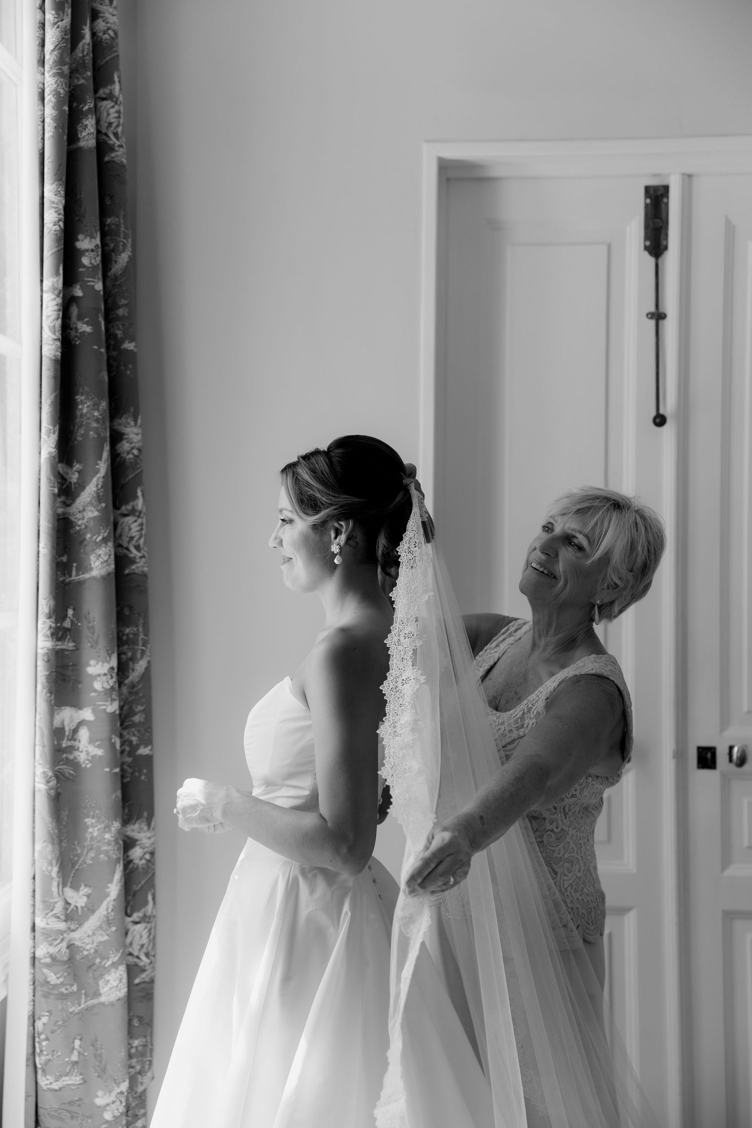 Series of elegant black and white photos showing wedding dress preparations.