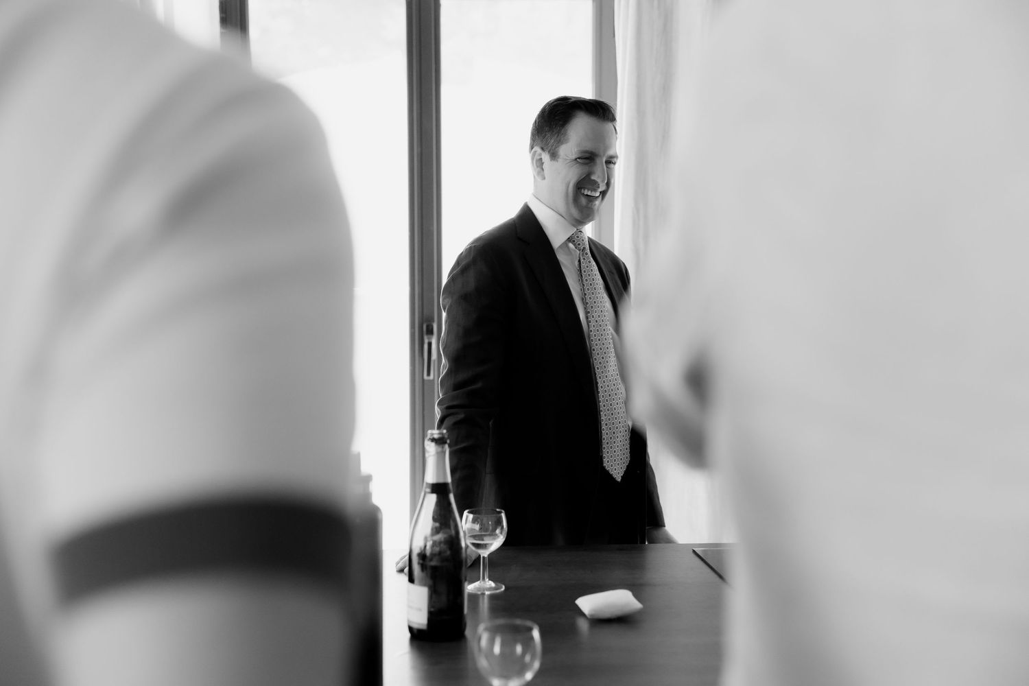Professional meeting scene with blurred figures in a modern office conference room setting.