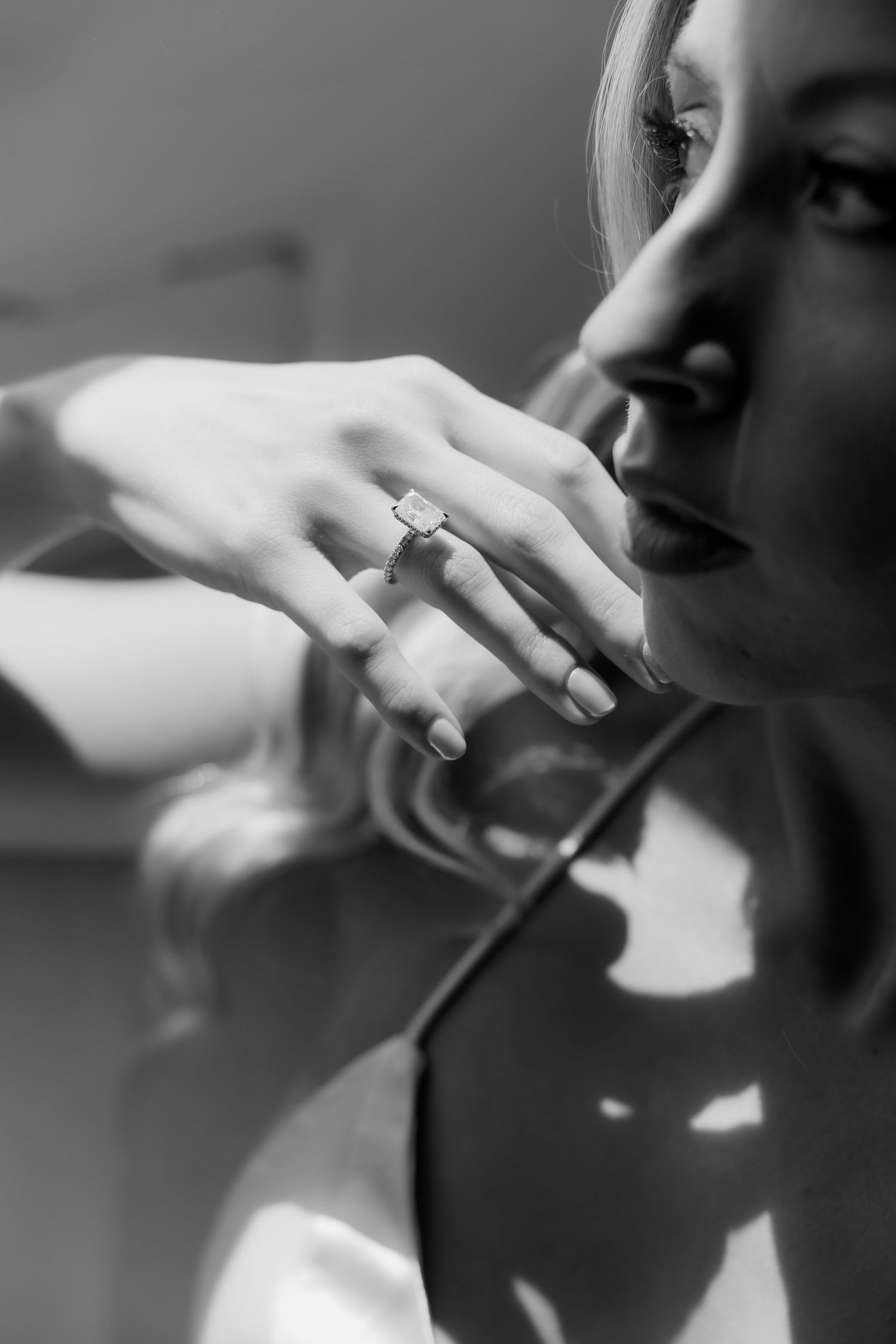 A black and white photo sequence showing hands with an engagement ring in an artistic composition.
