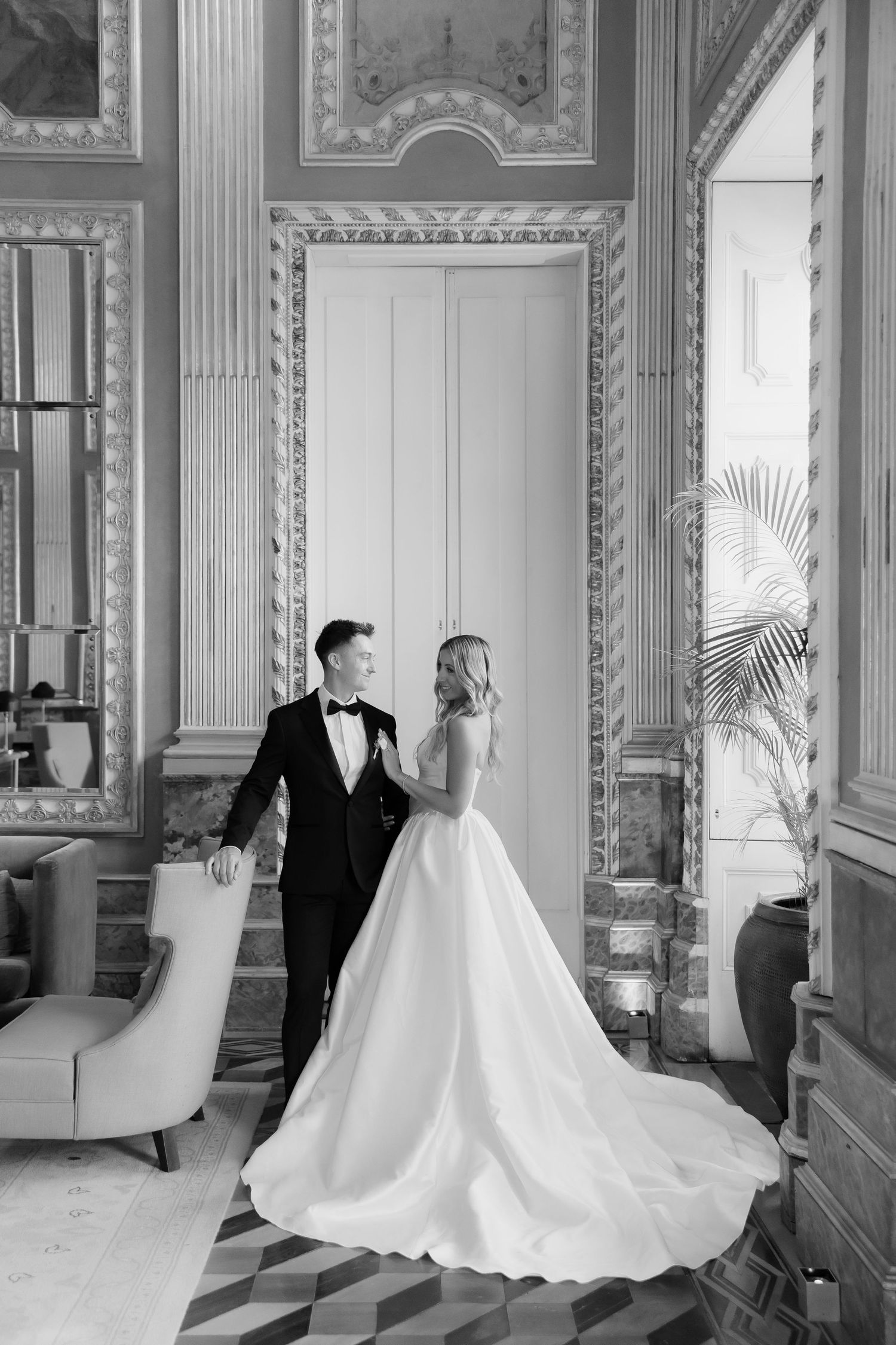 Elegant black and white wedding photos showing couple in formal attire posing in ornate classical interior.