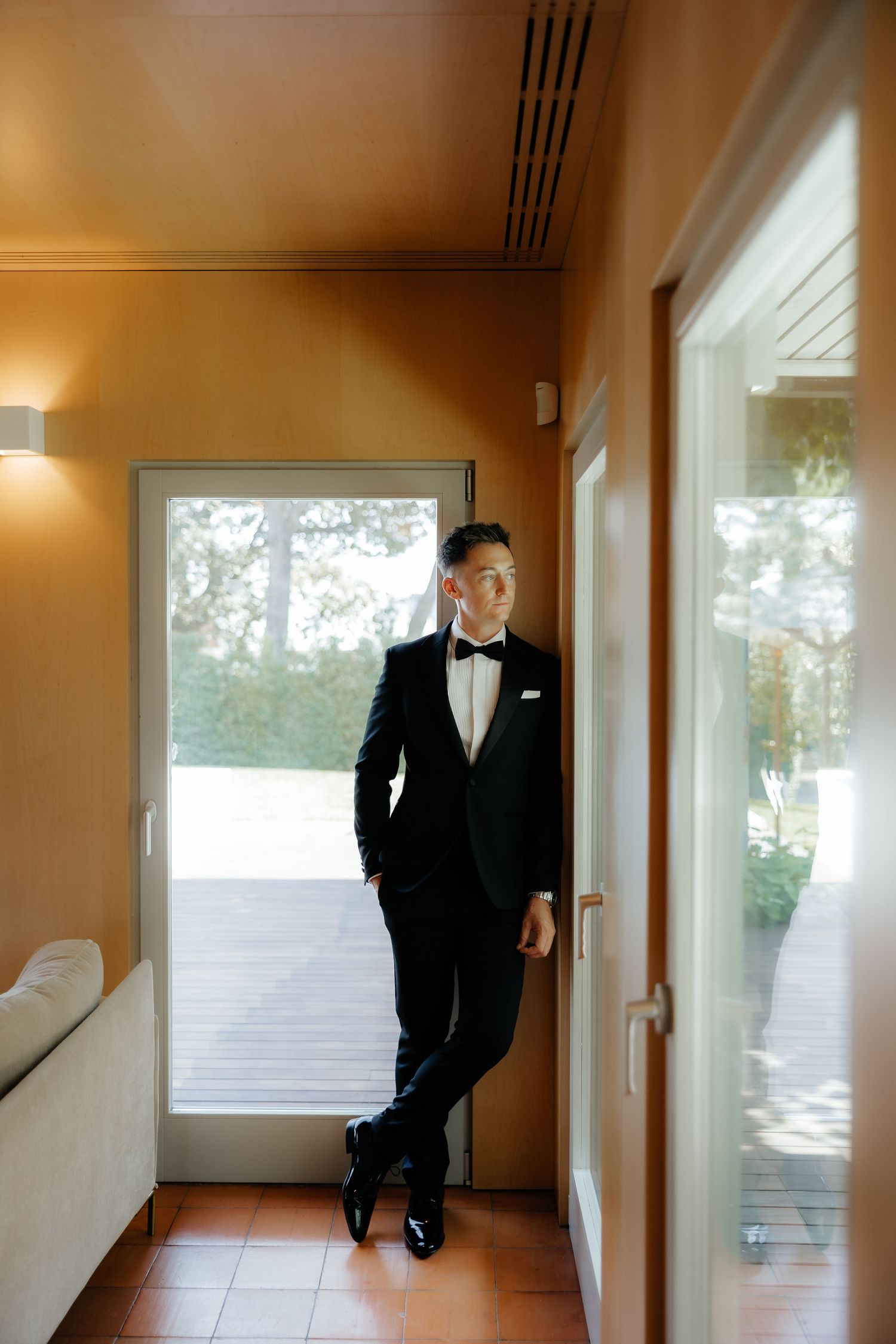 A sequence of artistic black and white photos showing a person in a suit walking down a minimalist hallway.