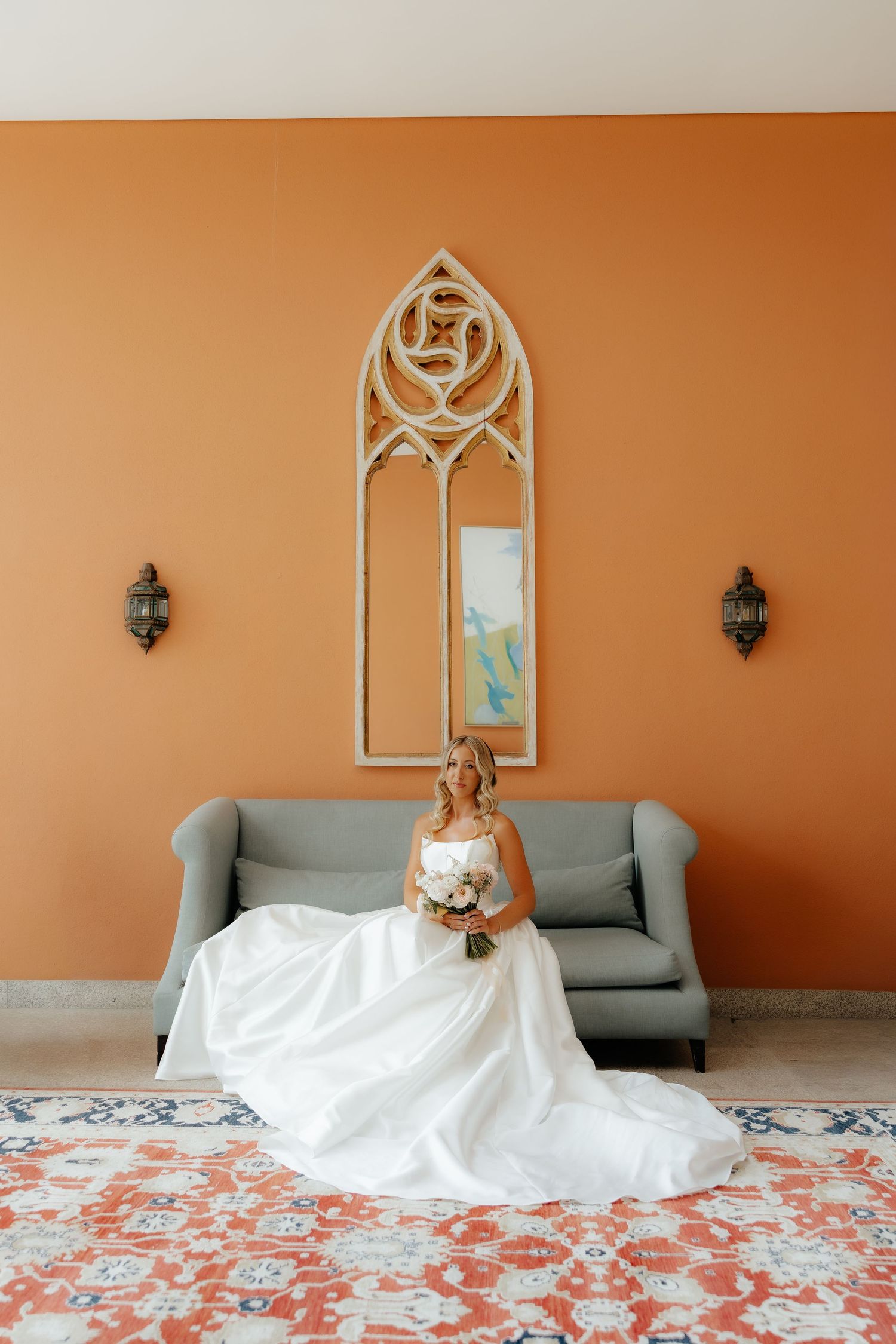 A sequence of photos showing a wedding dress laid out on a floral patterned floor against an orange wall with gray seating.