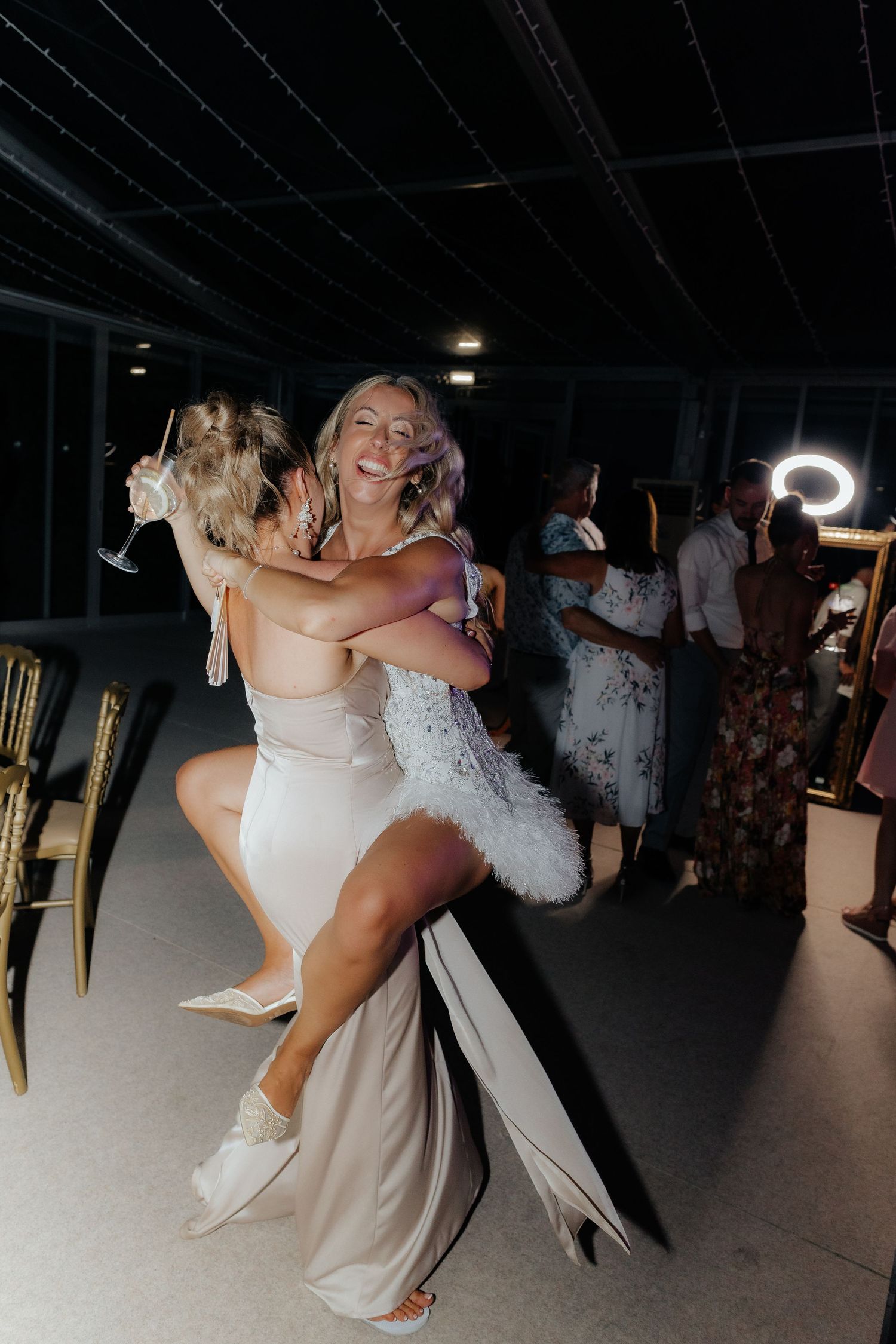 Wedding couple performs a romantic dip dance move on the dance floor during their reception celebration.