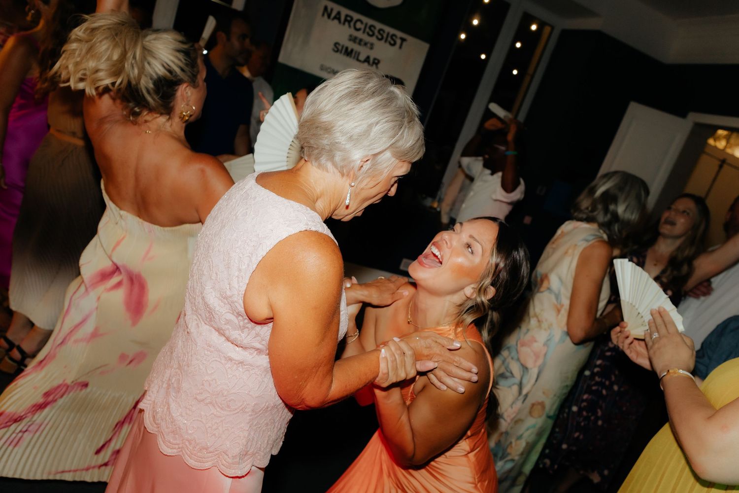 Collage of wedding reception dance floor moments showing guests celebrating and dancing together.