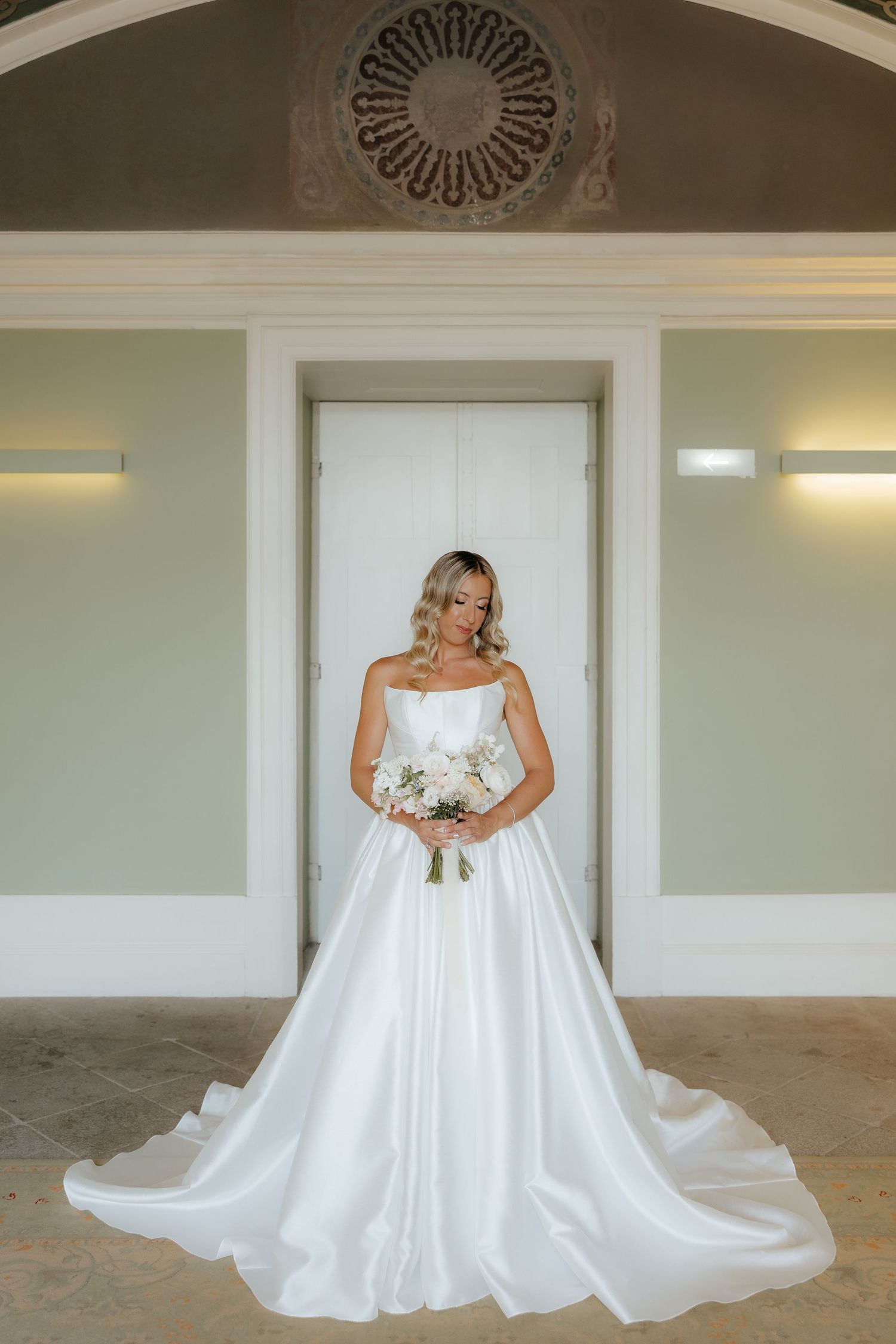 A flowing white wedding dress with a full skirt is shown in a sequence of photos displaying its elegant movement and train.