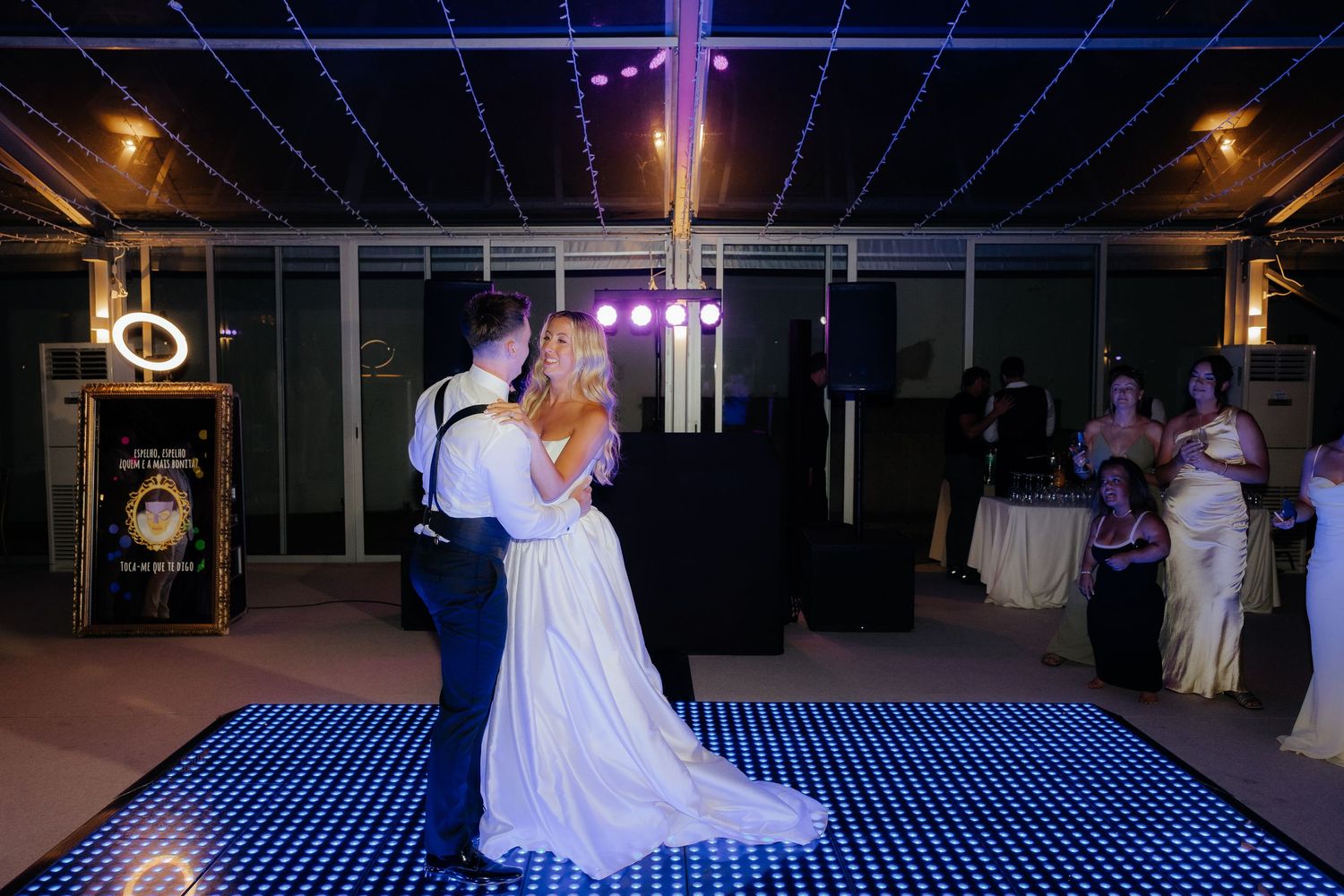 A series of wedding photos showing couples dancing on a glowing LED dance floor at an indoor reception venue.