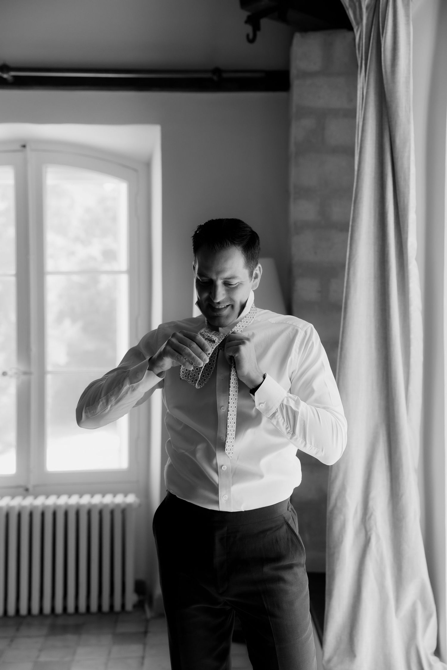 Black and white portrait series showing a person in a white shirt against a bright window.