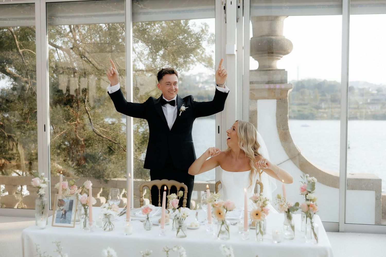 A wedding celebration sequence showing joyful moments at a waterfront venue with elegant white and gold decor.