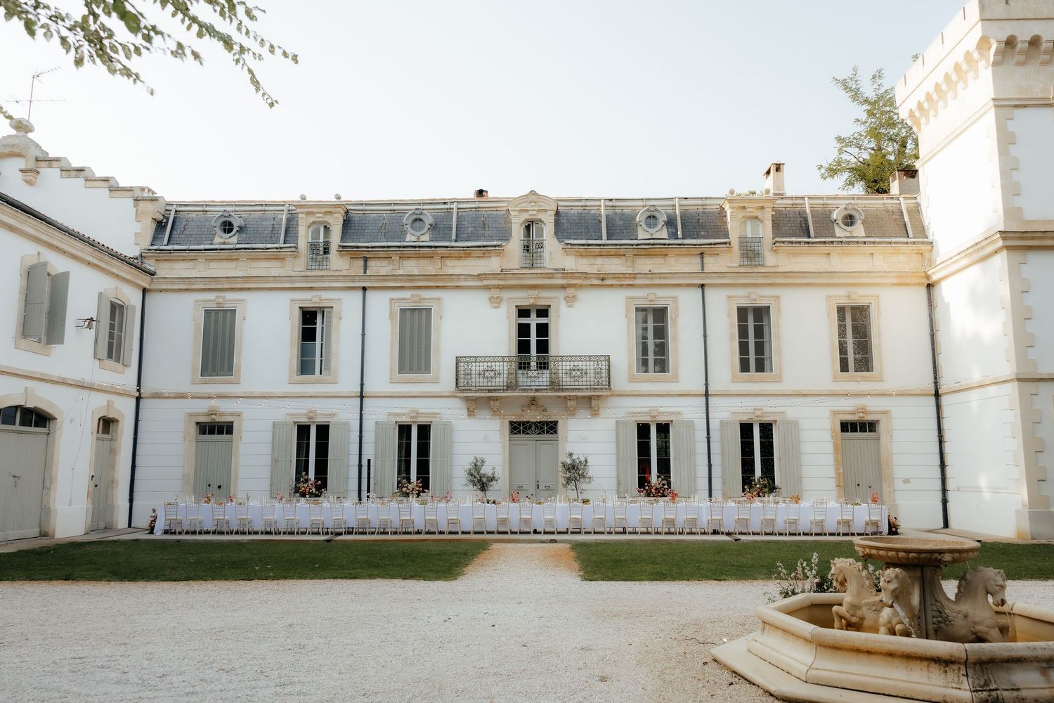 Historic white colonial building with ornate architectural details and arched windows stretches across a panoramic view.